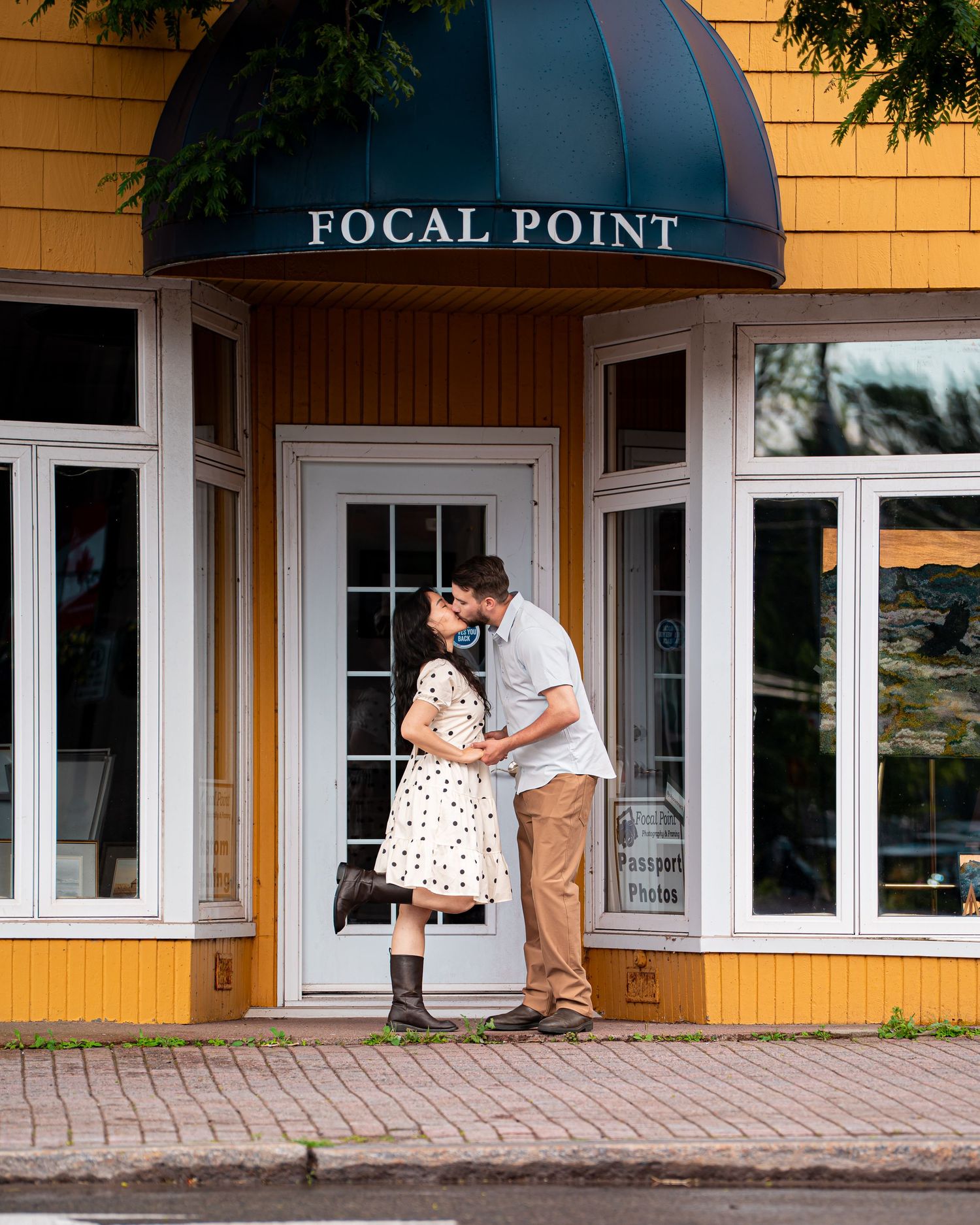 Romantic couple kissing during a engagement session in downtown in Moncton, NB. Engagement city shoot