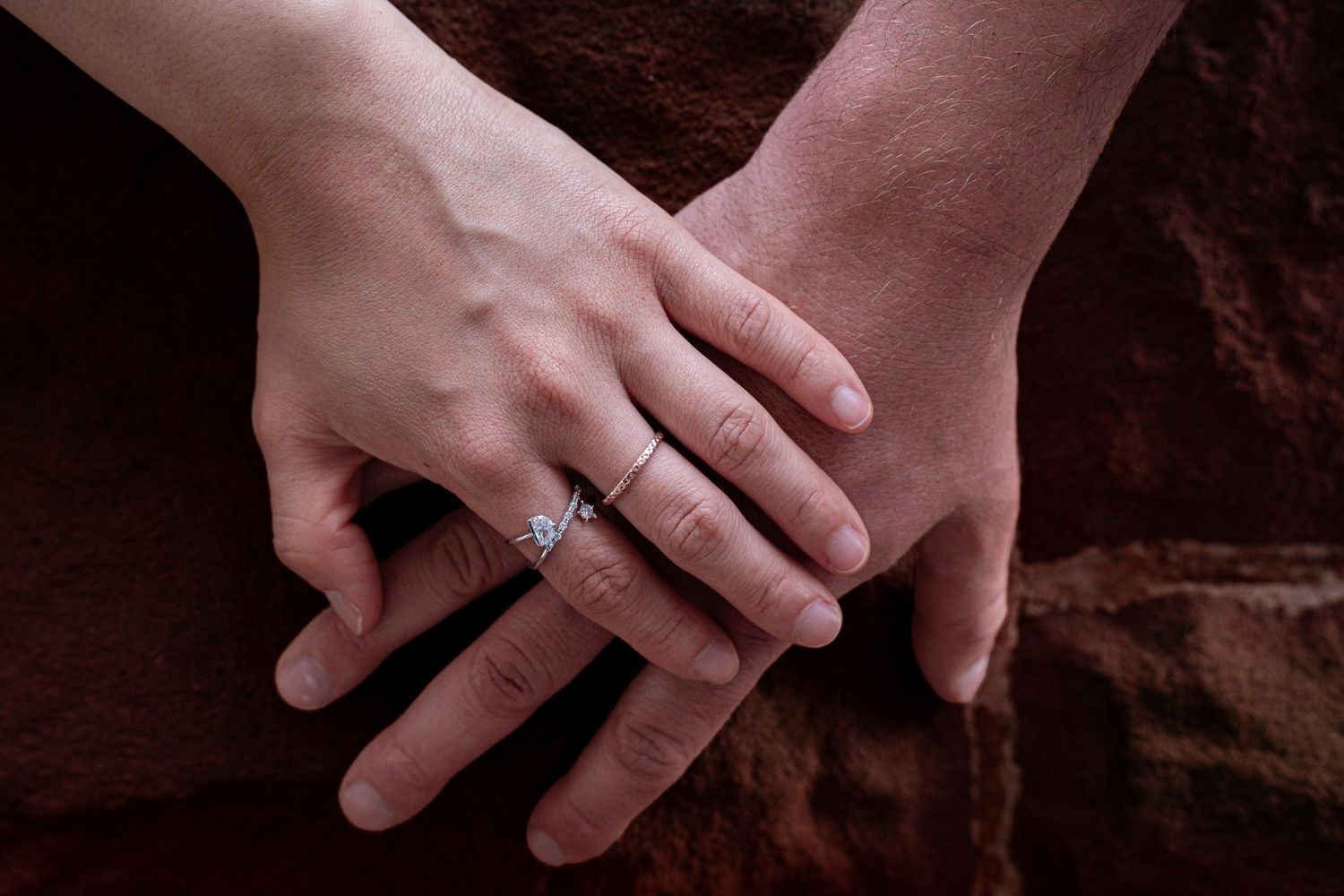 Romantic couple holding hands during a golden hour engagement session in downtown in Moncton, NB. Engagement city shoot