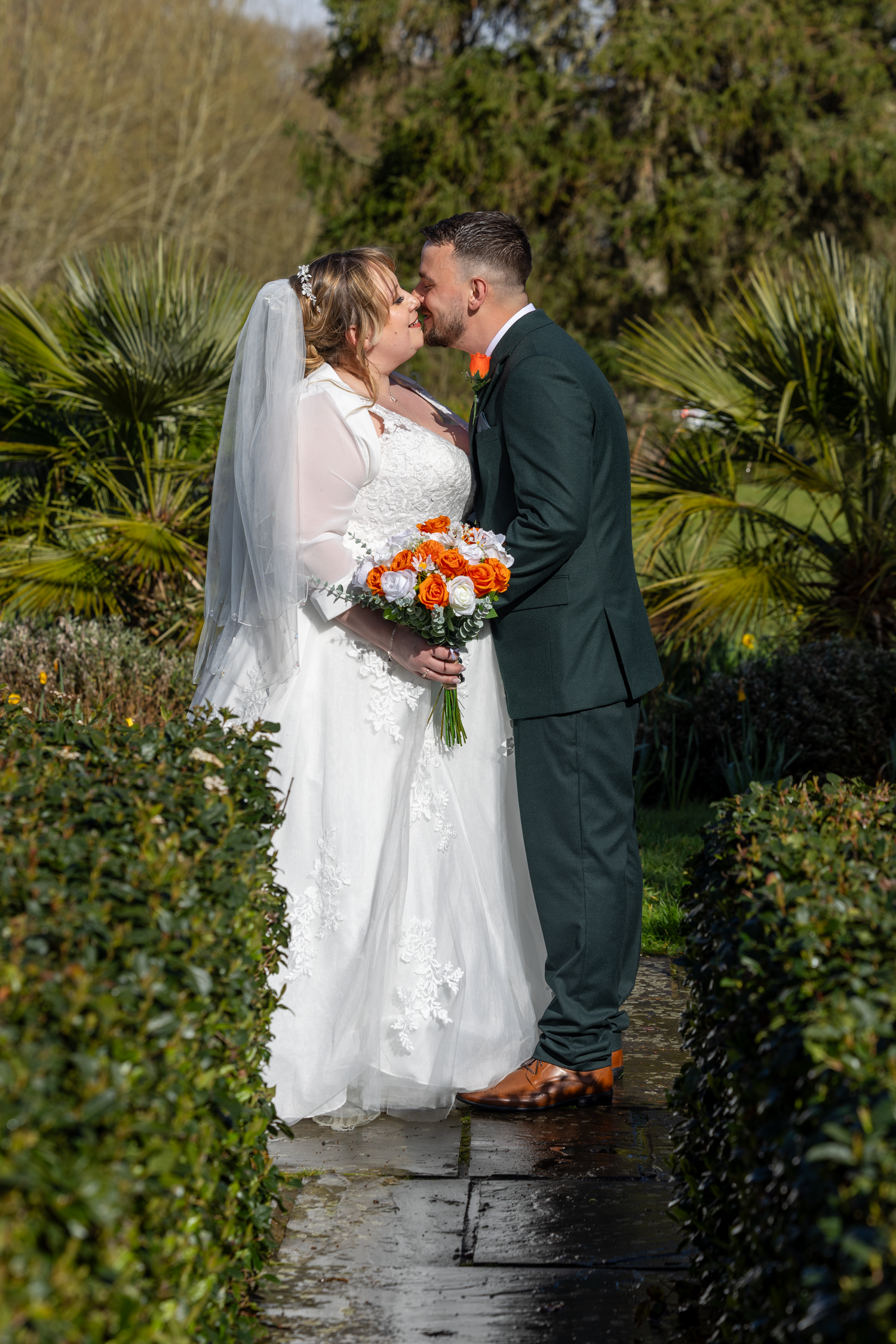 Couple kissing in the grounds of southdowns manor