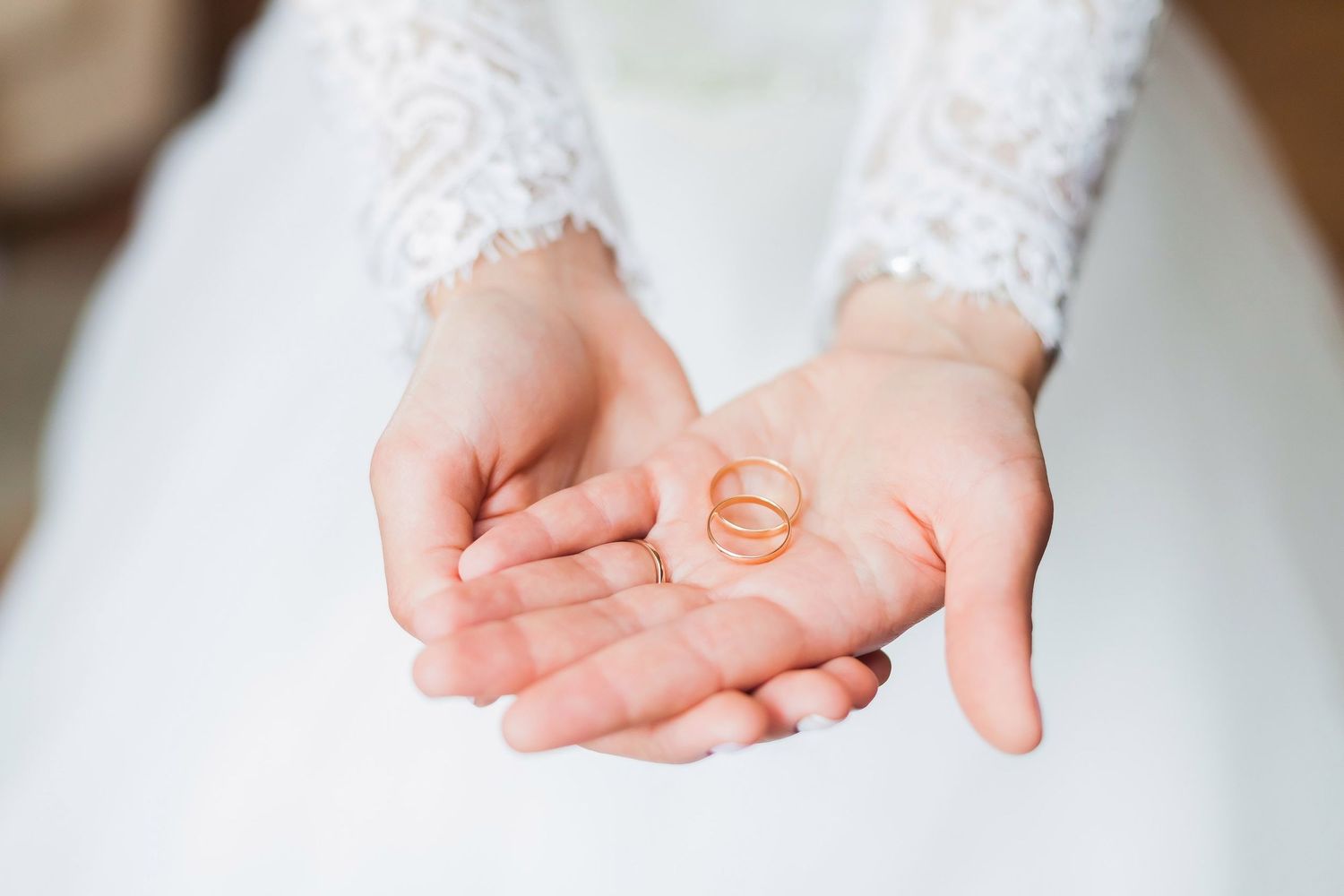 Bride holding wedding rings