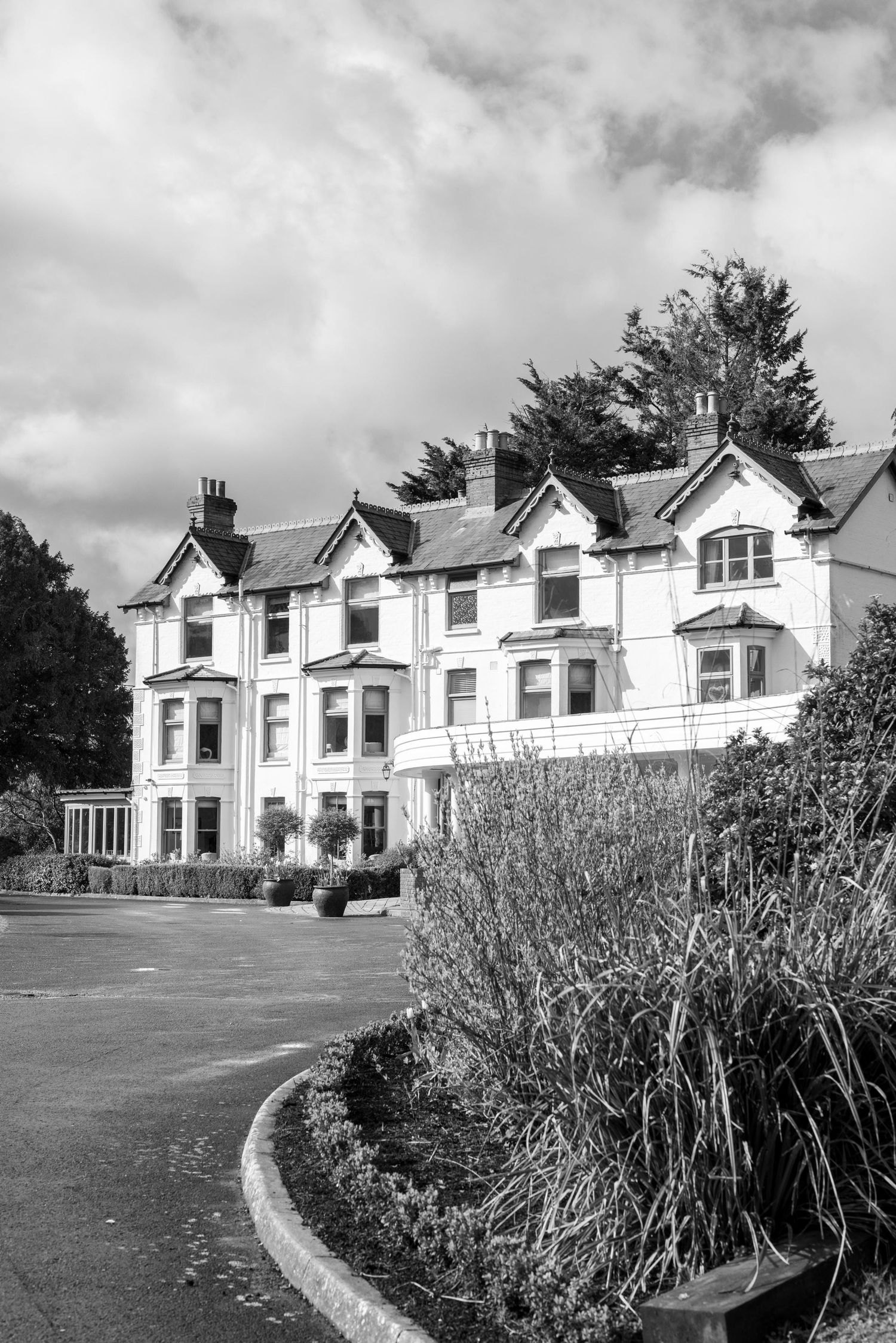 Black and white establishing Location photo of South Downs Manor