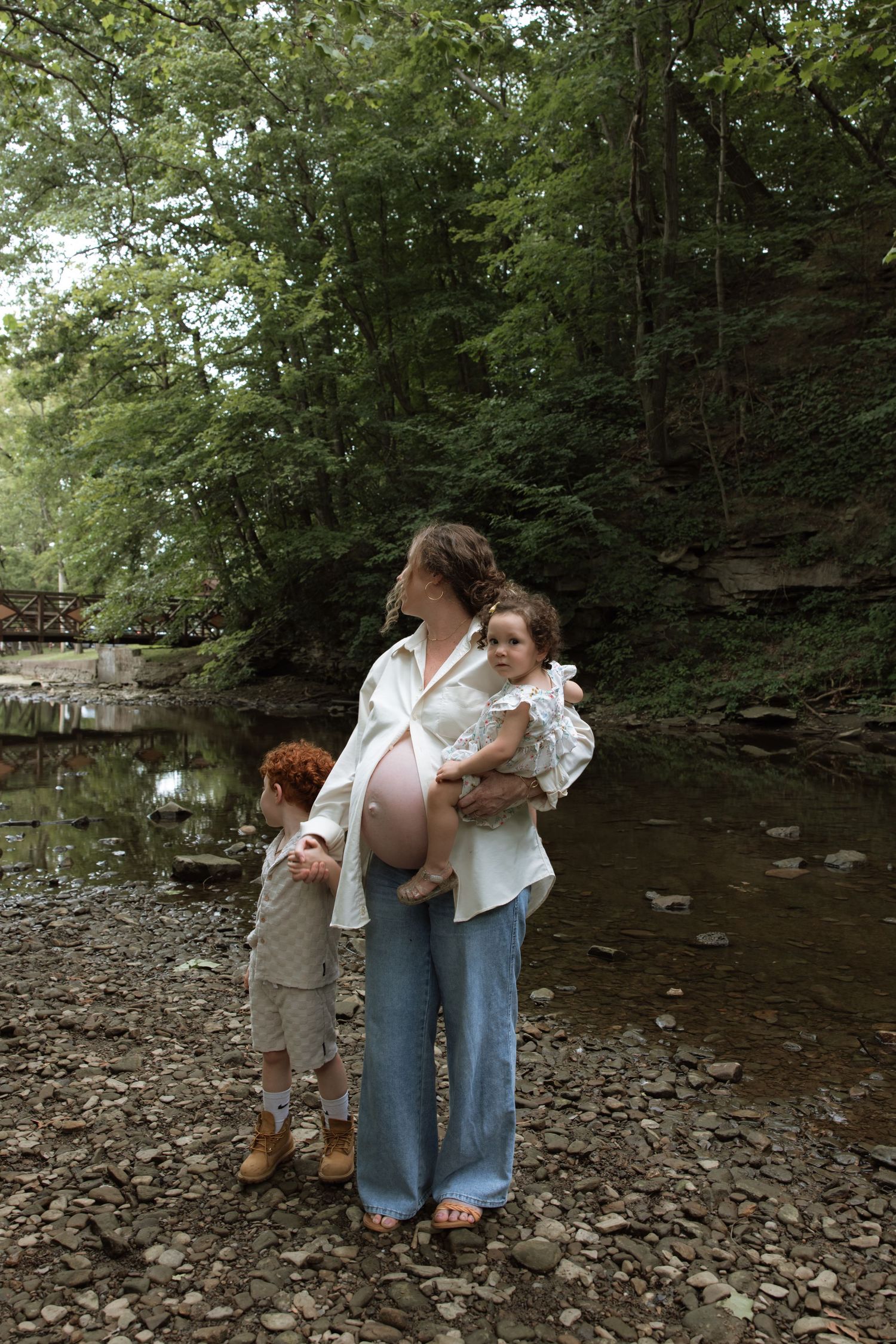 A series of candid moments showing people by a rocky creek in a wooded area.