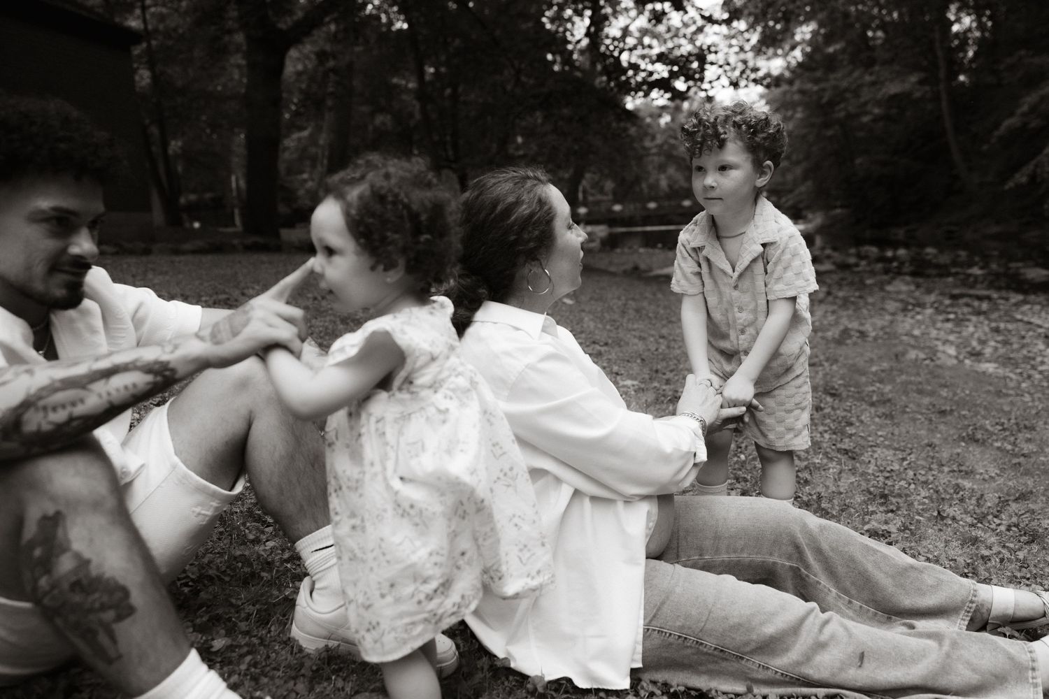 A collage of romantic black and white photographs showing tender moments between couples embracing in outdoor settings.