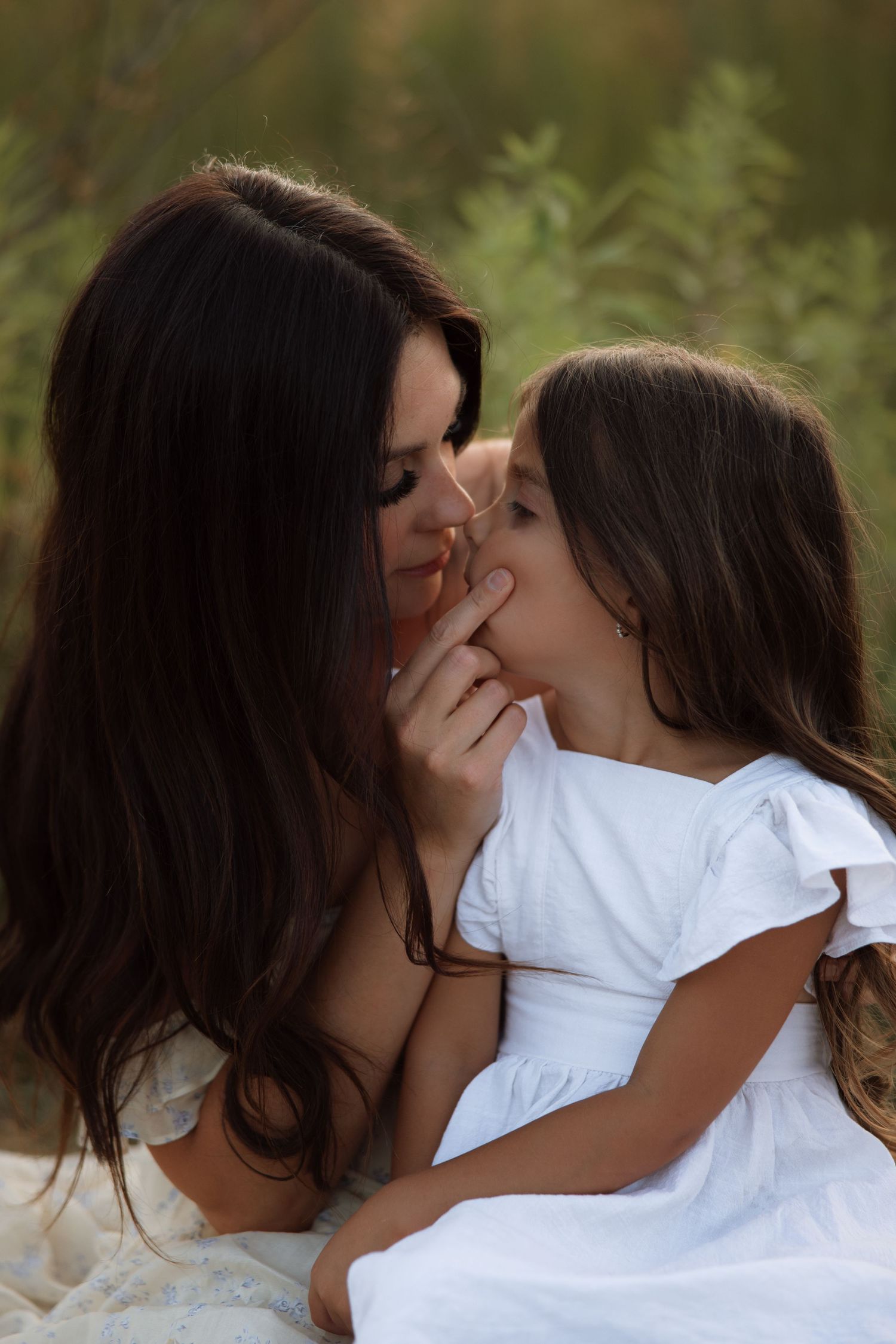 A sequence of intimate photos showing a couple in white shirts sharing tender moments against a blurred natural background.