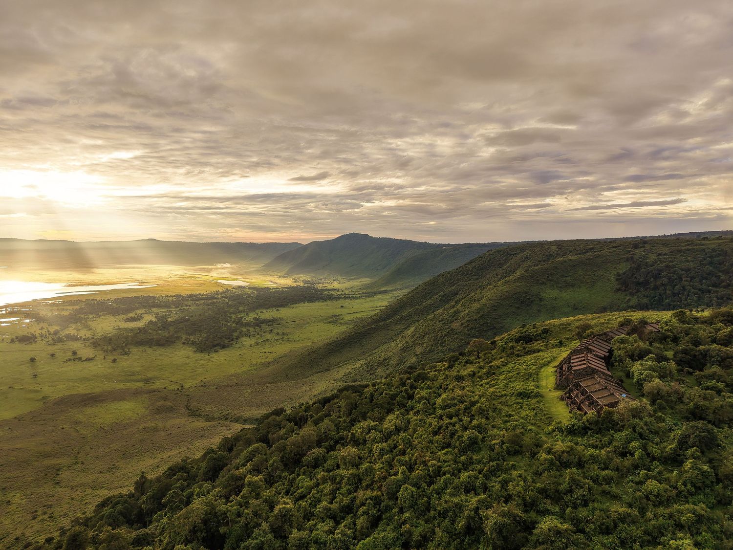 Aerial 8K view of a remote luxury camp; professional Tanzania tourism cinematography and licensed drone services.