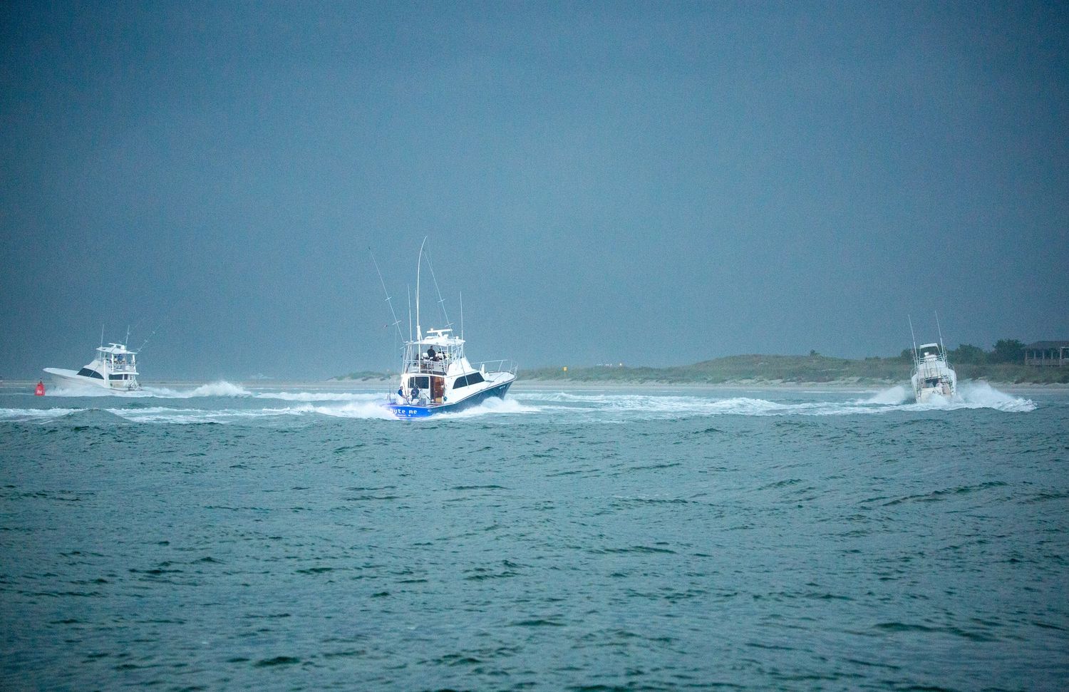 A fishing boat navigates through rough ocean waves during stormy conditions at sea.