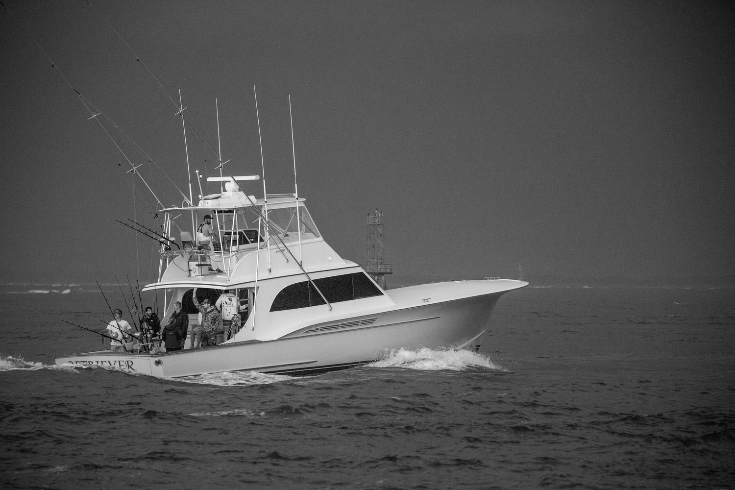 Charter boats navigating through dark choppy waters during stormy weather.
