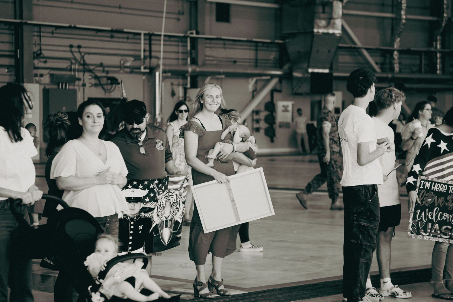 Black and white photograph showing students gathered in a gymnasium during what appears to be a school dance event.