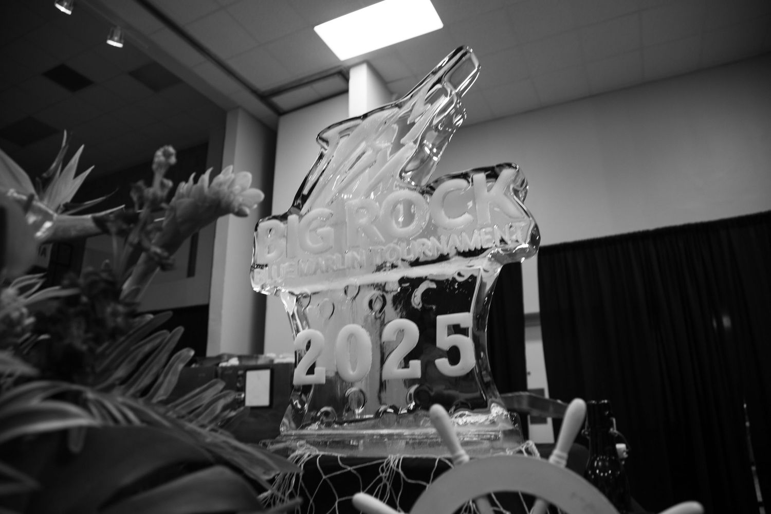 Elegant ice sculpture with numerical design displayed under indoor lighting.