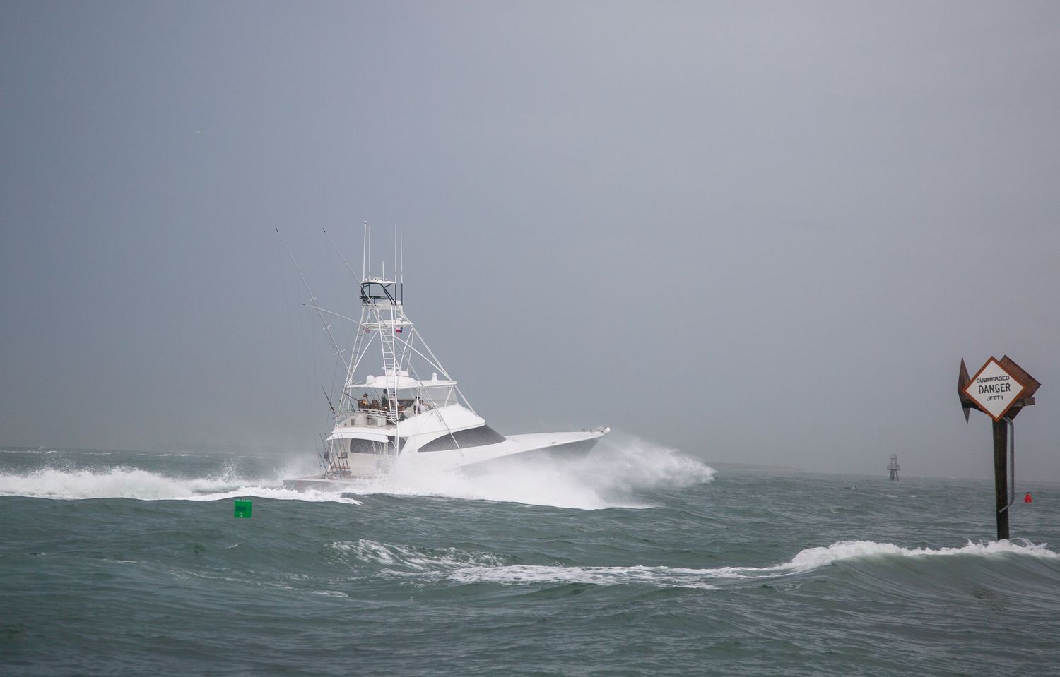 Sport fishing boats battle through rough seas under overcast skies.