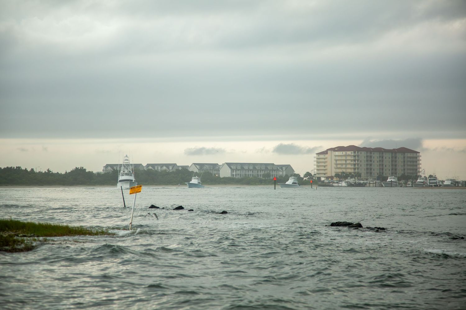 Panoramic view of waterfront buildings and coastline on an overcast day.