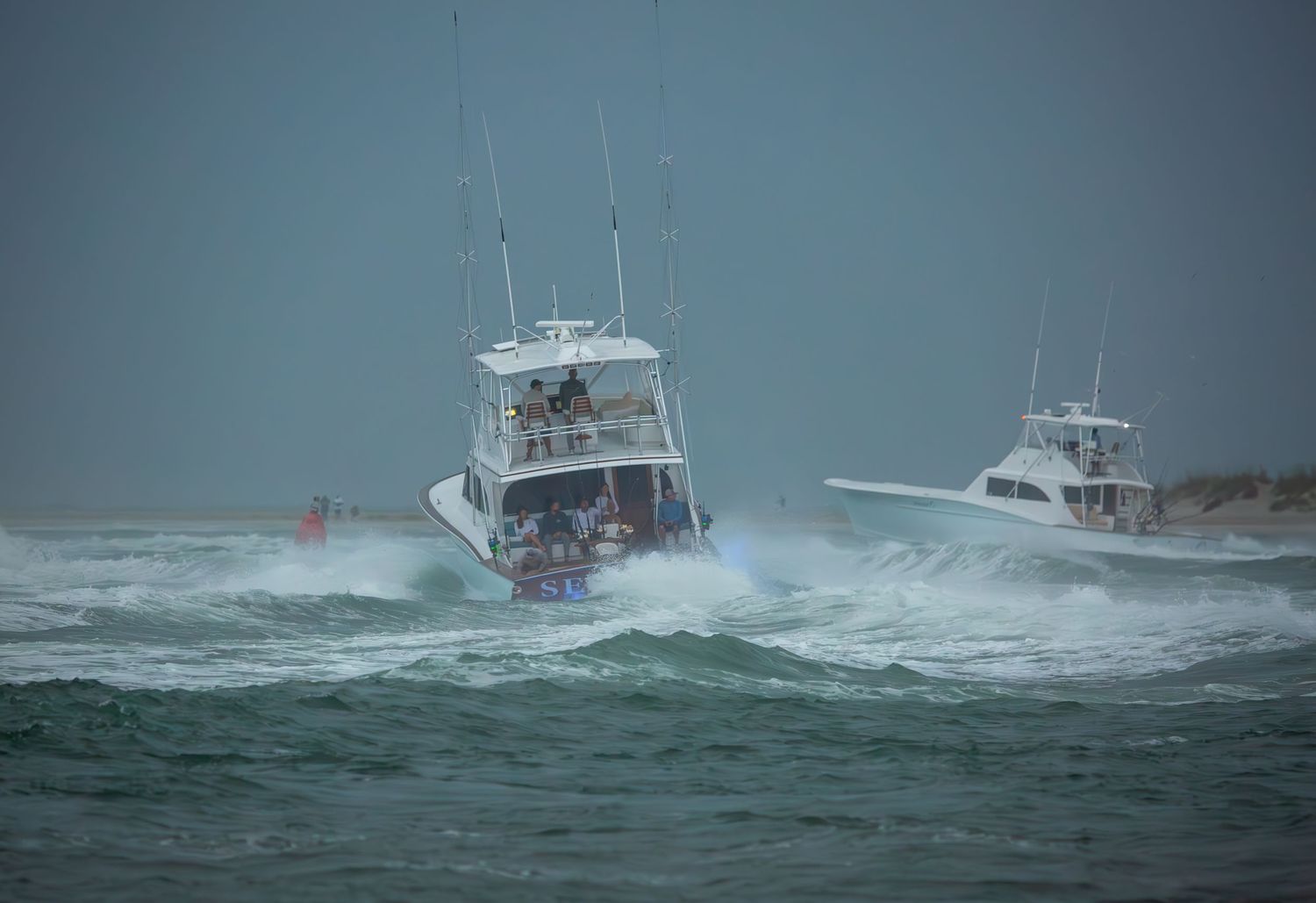 Center console boat powers through large ocean swells on stormy seas.