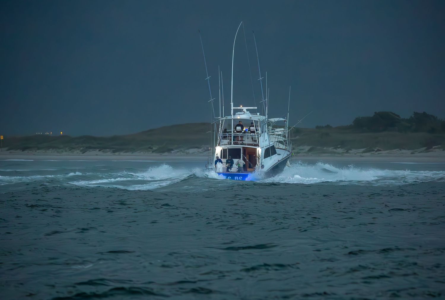 White fishing boats navigate through stormy waters with large waves in the background.
