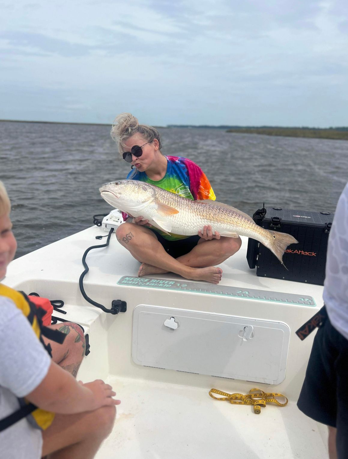 Fishing adventure sequence showing catch and release of redfish from boat deck.