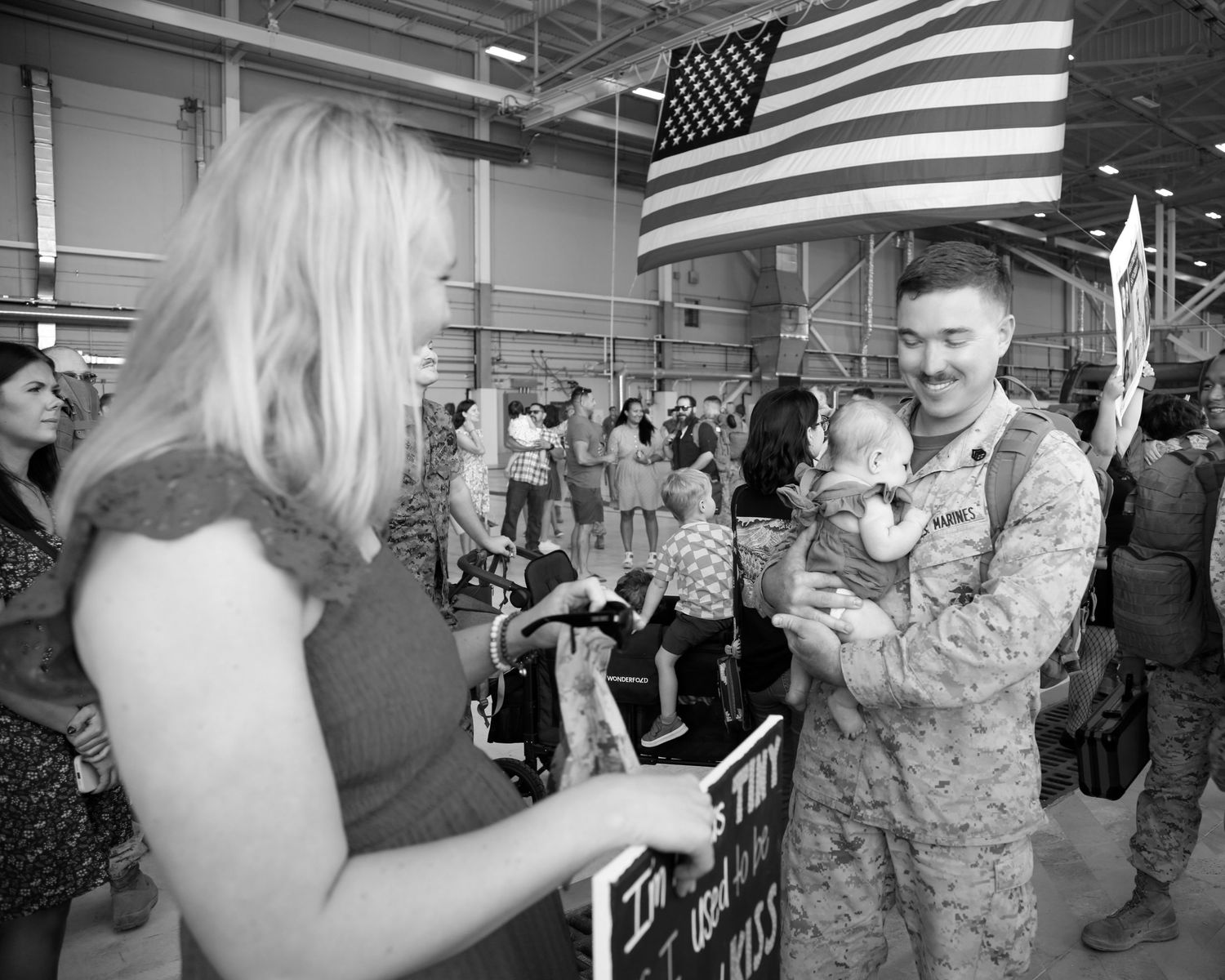 A sequence of black and white photos showing emotional military homecoming moments at an airport terminal.