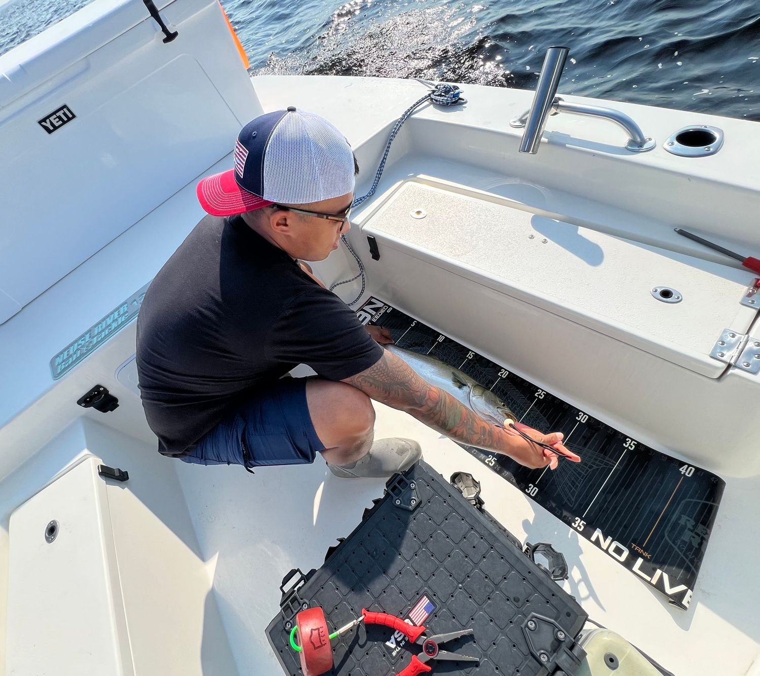 Fishing equipment and deck gear visible on a white boat during a day of ocean fishing.