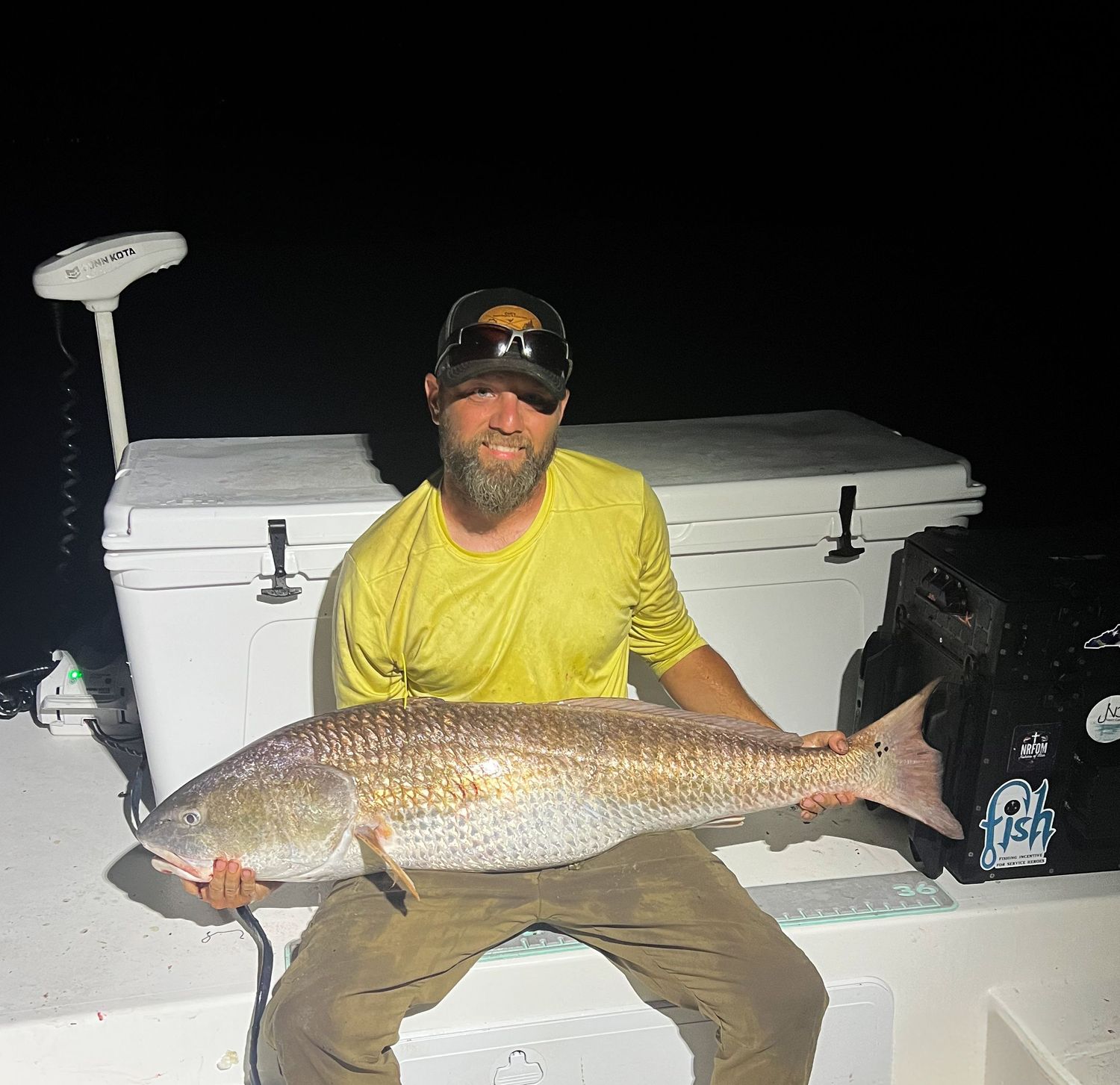 Night fishing photos showing large redfish catches displayed on a boat deck.