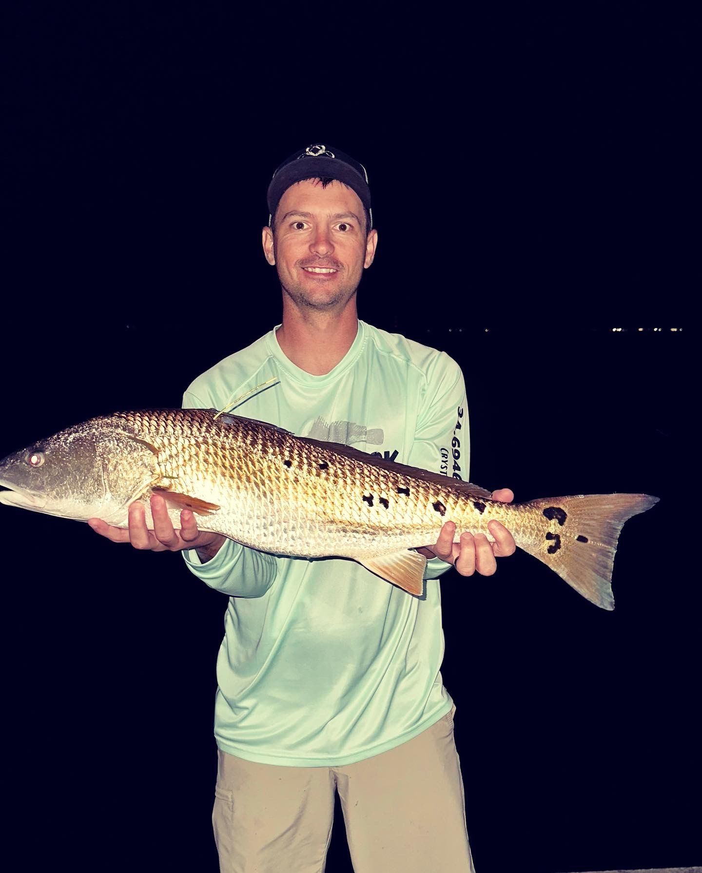Night fishing trip yields impressive redfish catches displayed on boat deck.