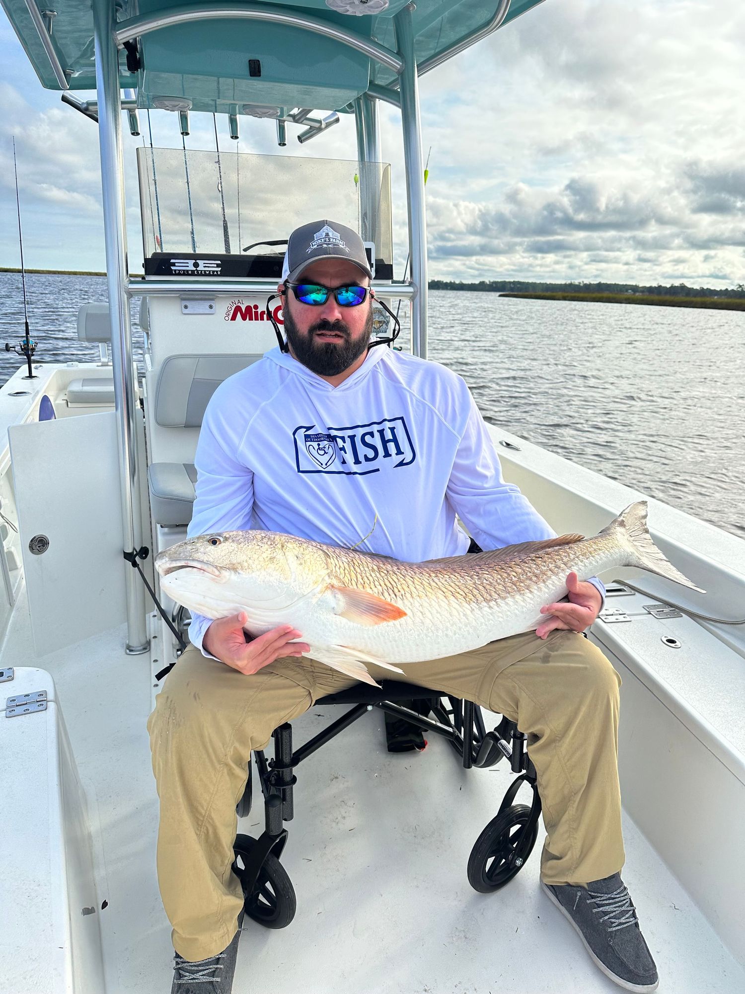 Series of successful catches displayed by anglers in wheelchairs on a fishing boat.