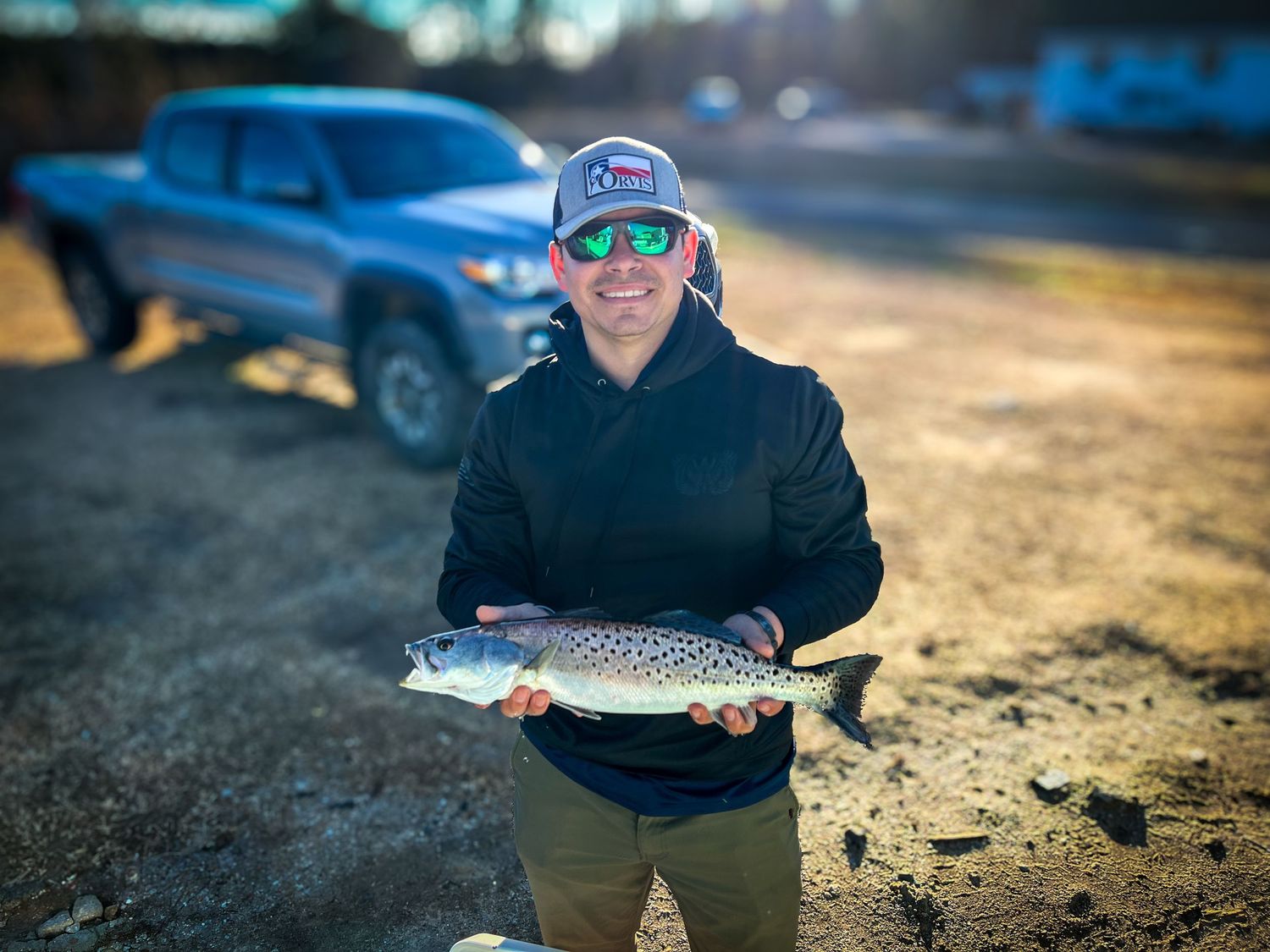 Winter fishing success with caught trout displayed in cold weather.