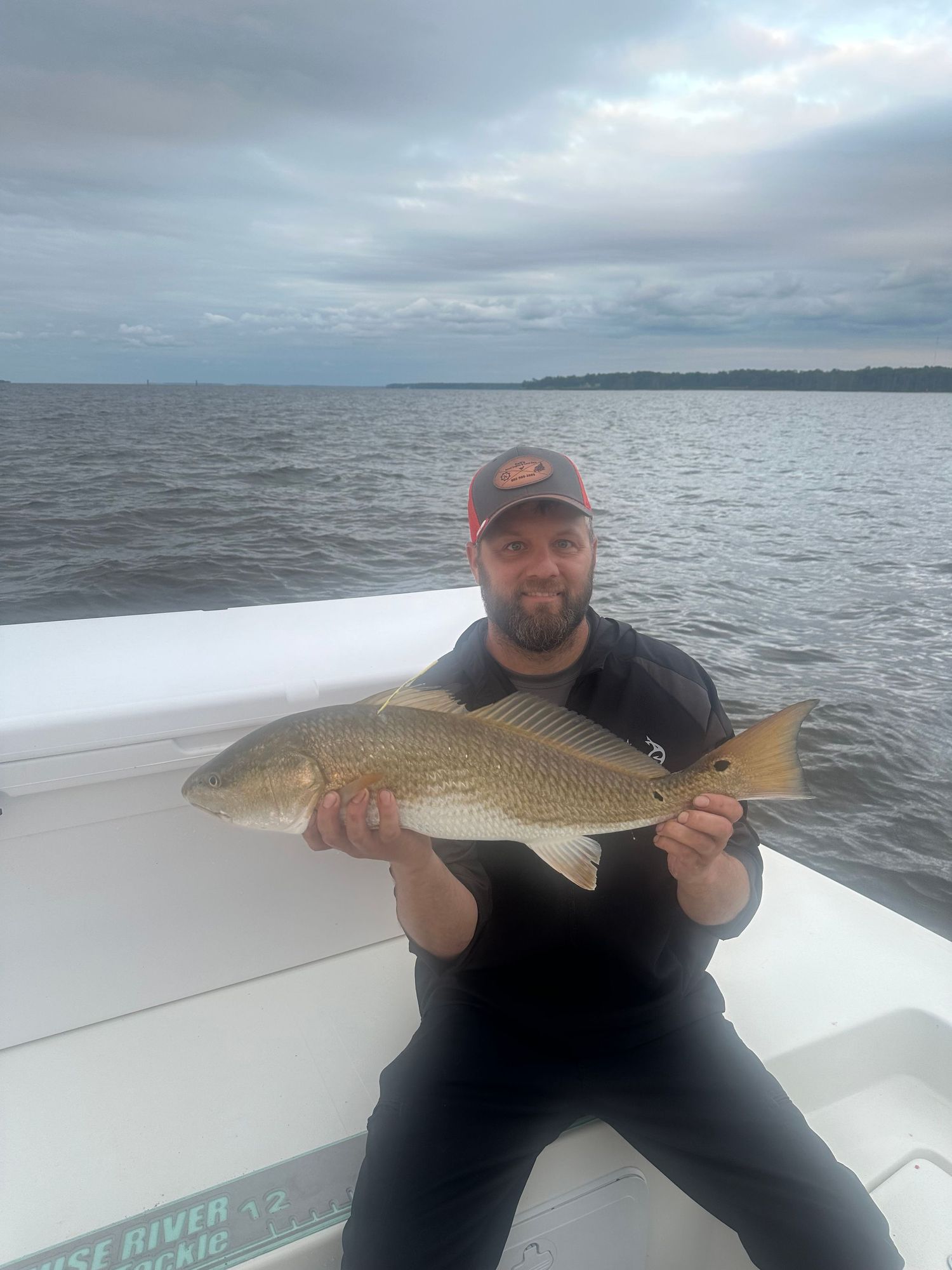 Overcast day fishing photos showing redfish catches on a white boat deck.
