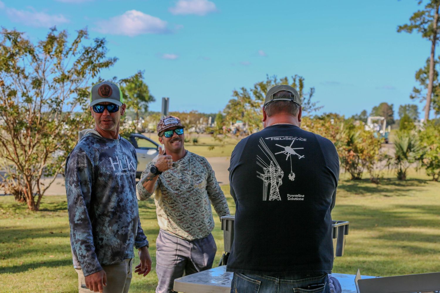 Group of participants gathered at outdoor fishing tournament event.