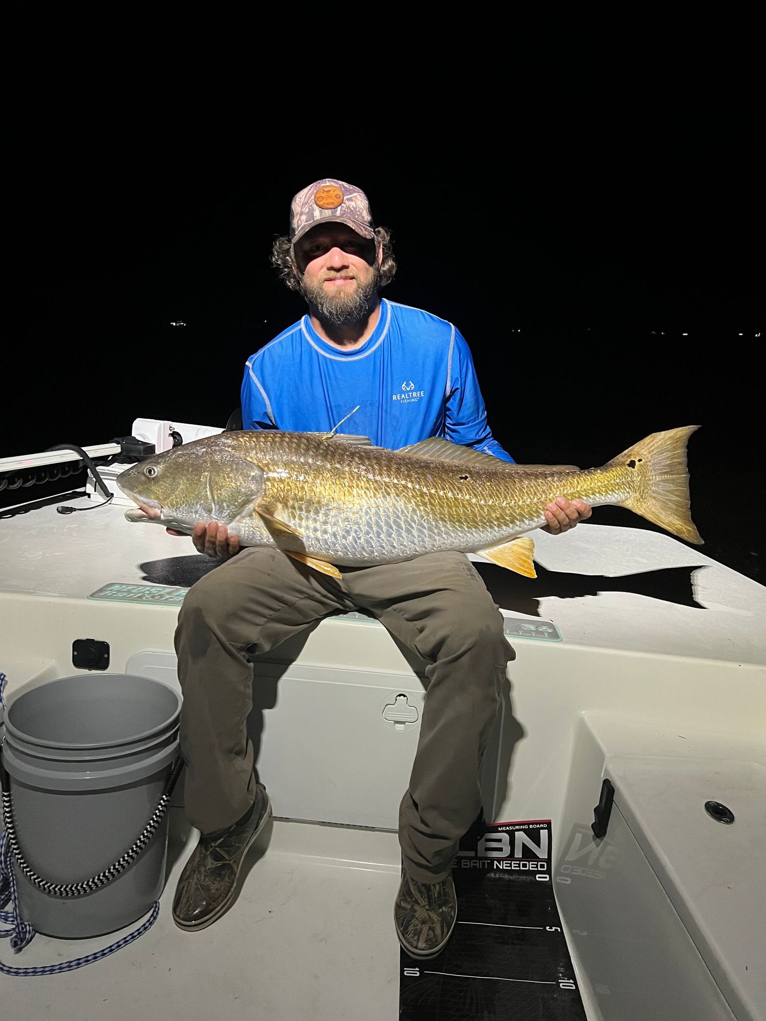Red drum catch displayed on boat deck during night fishing trip.