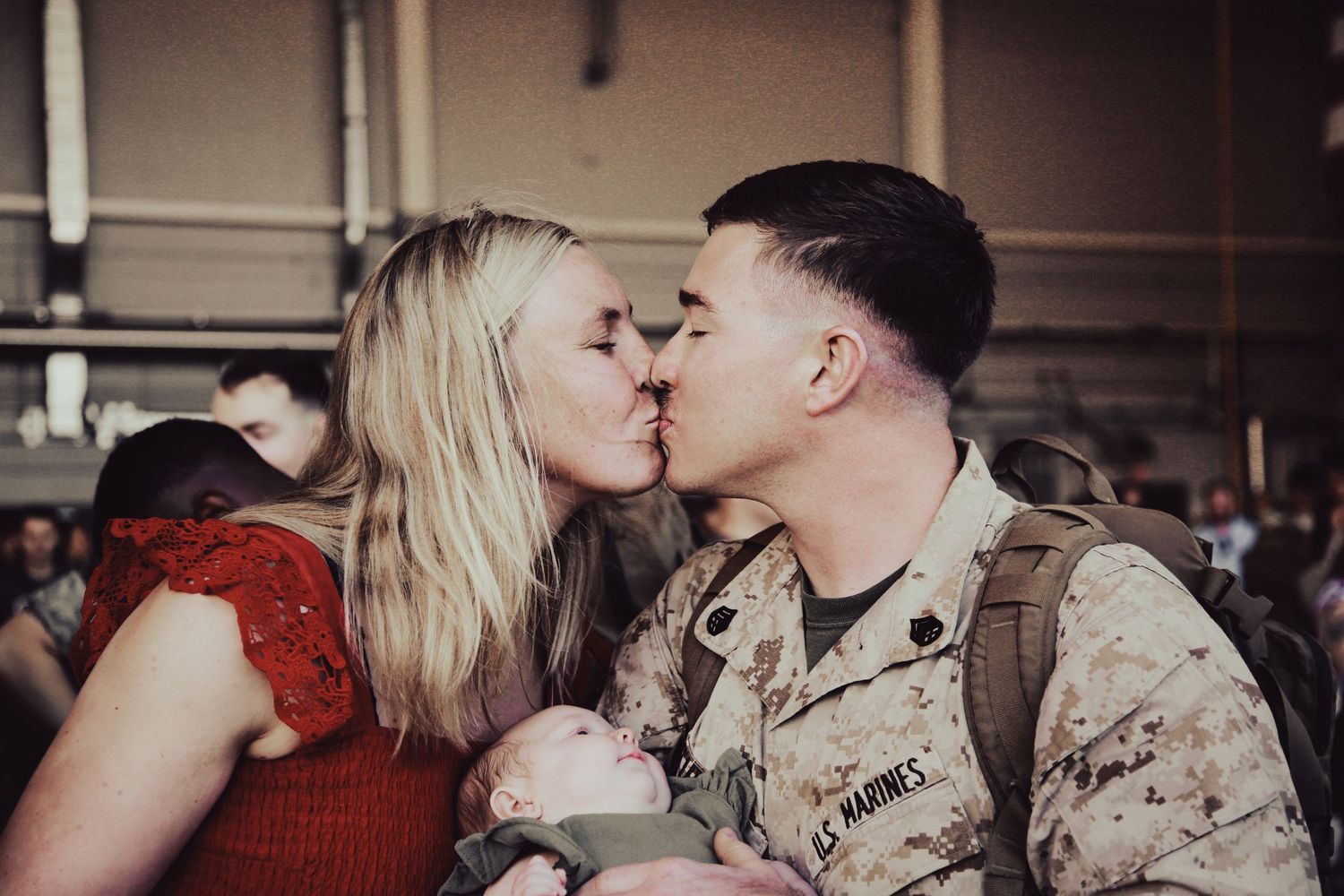 Emotional reunion moments between service members and loved ones at a military homecoming event.