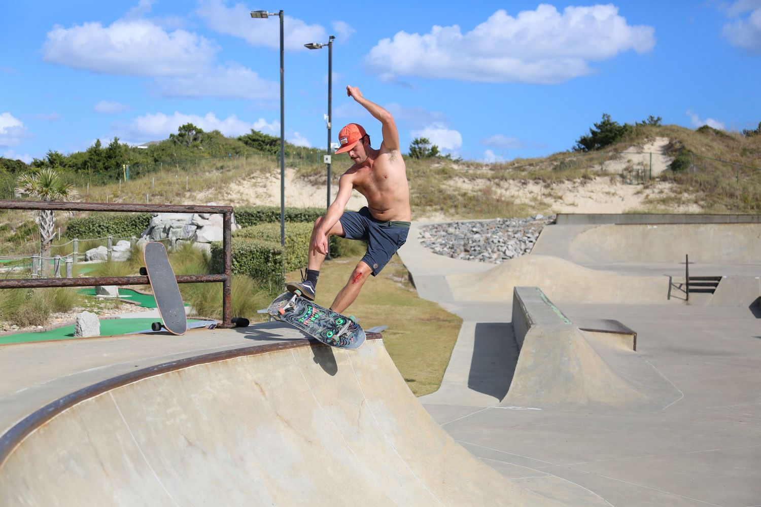 Skateboarding sequence shows person performing tricks at a concrete skate park on a sunny day.