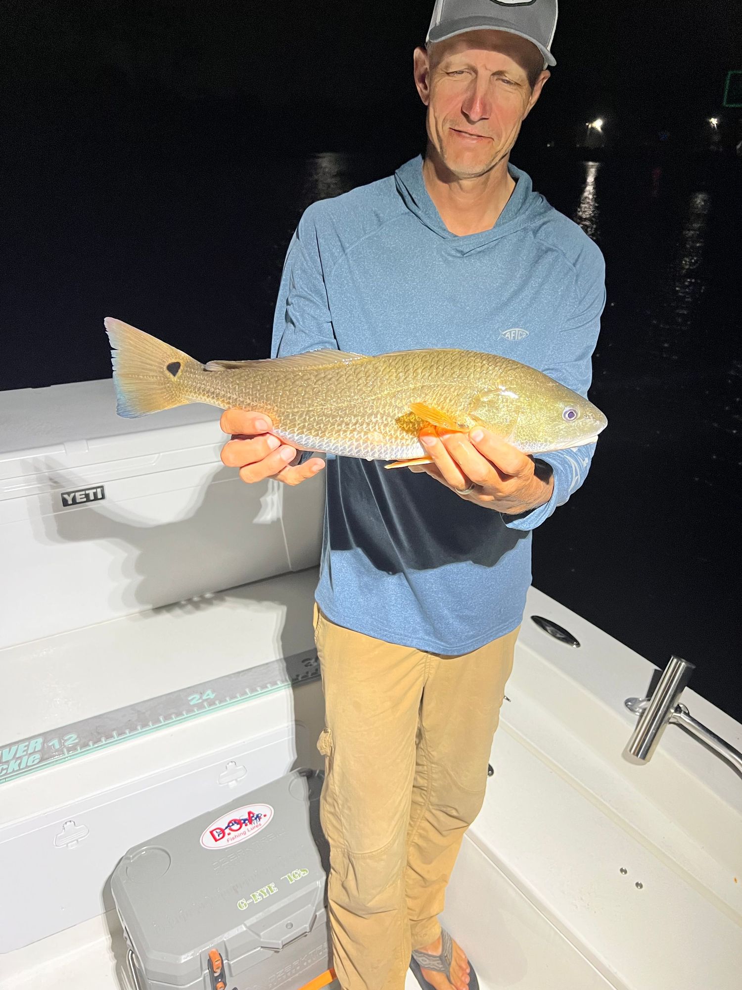 Nighttime fishing photos showing catches of redfish on a white boat deck.