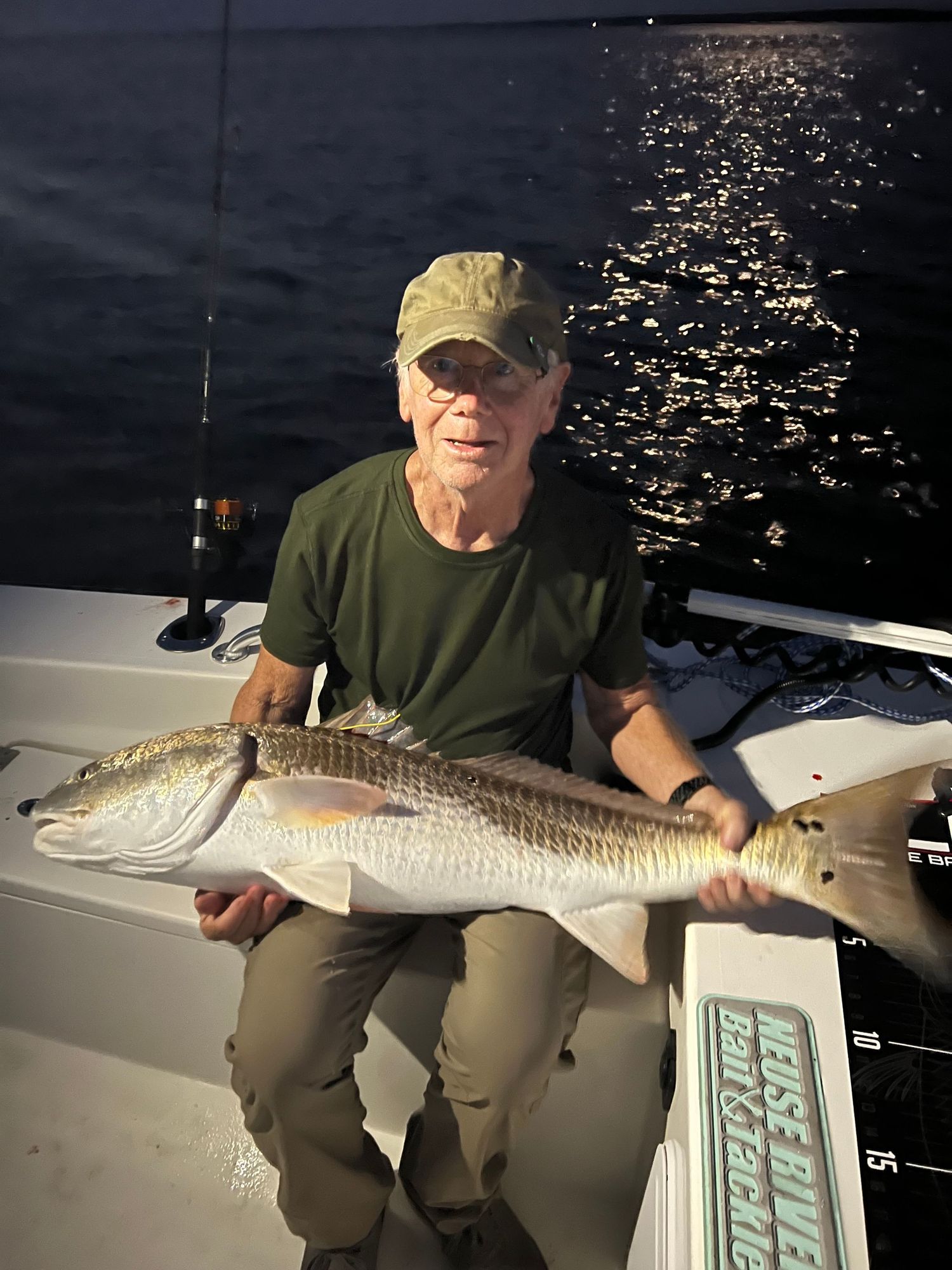 Large redfish caught during evening fishing trip on boat deck.