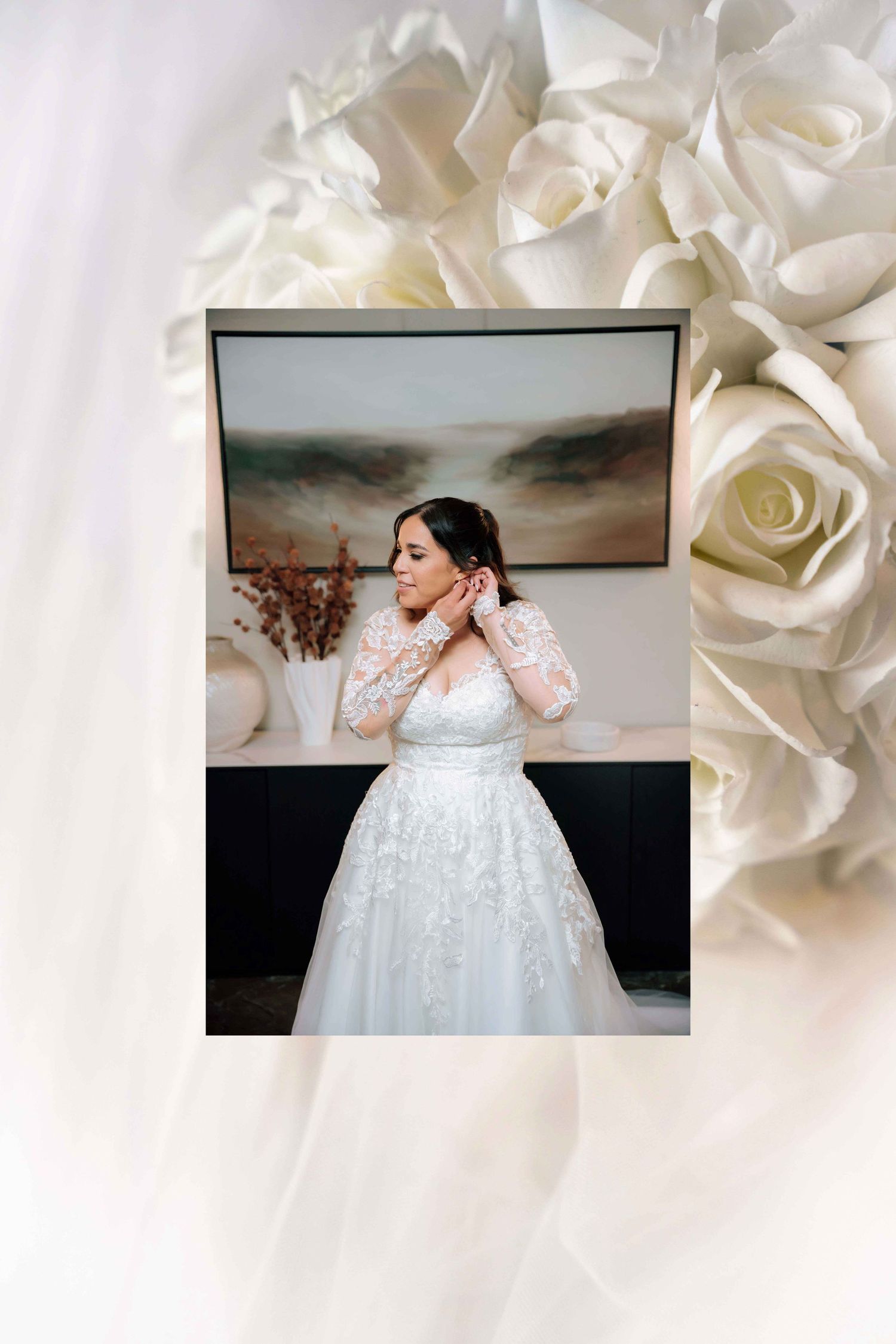 Polaroid-style photo of bride in lace gown adjusting earrings, framed by white roses bouquet.