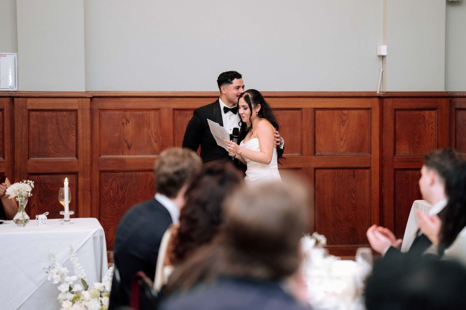 Bride and groom share first dance at elegant wedding reception venue.
