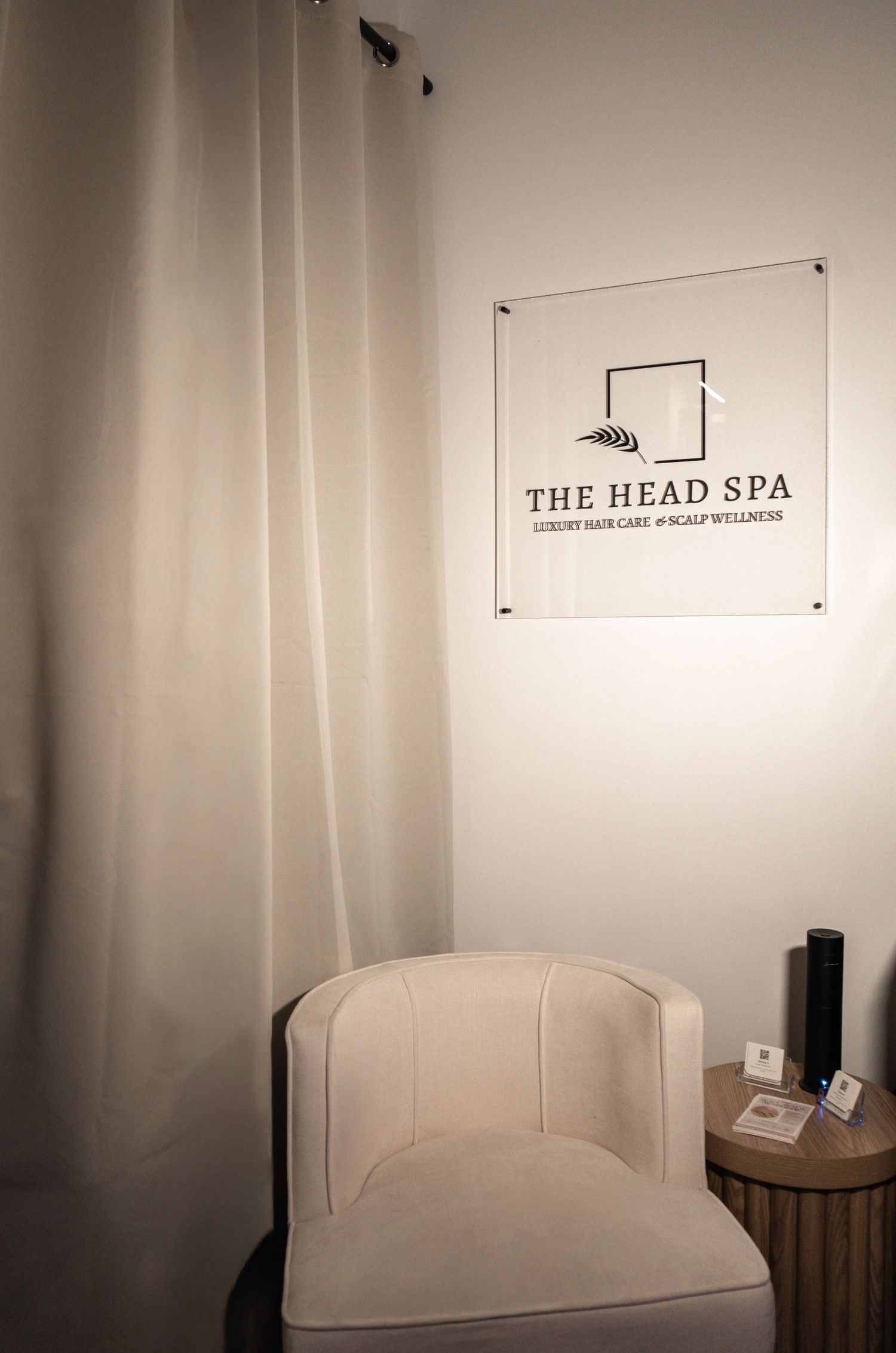 A series of minimalist spa interior photos showing white walls, signage, and furniture in a serene setting.