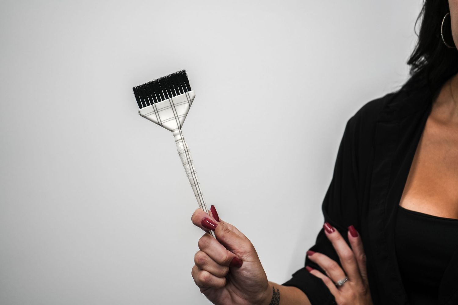 Sequence of close-up shots showing someone holding a glass wine stopper against dark background.