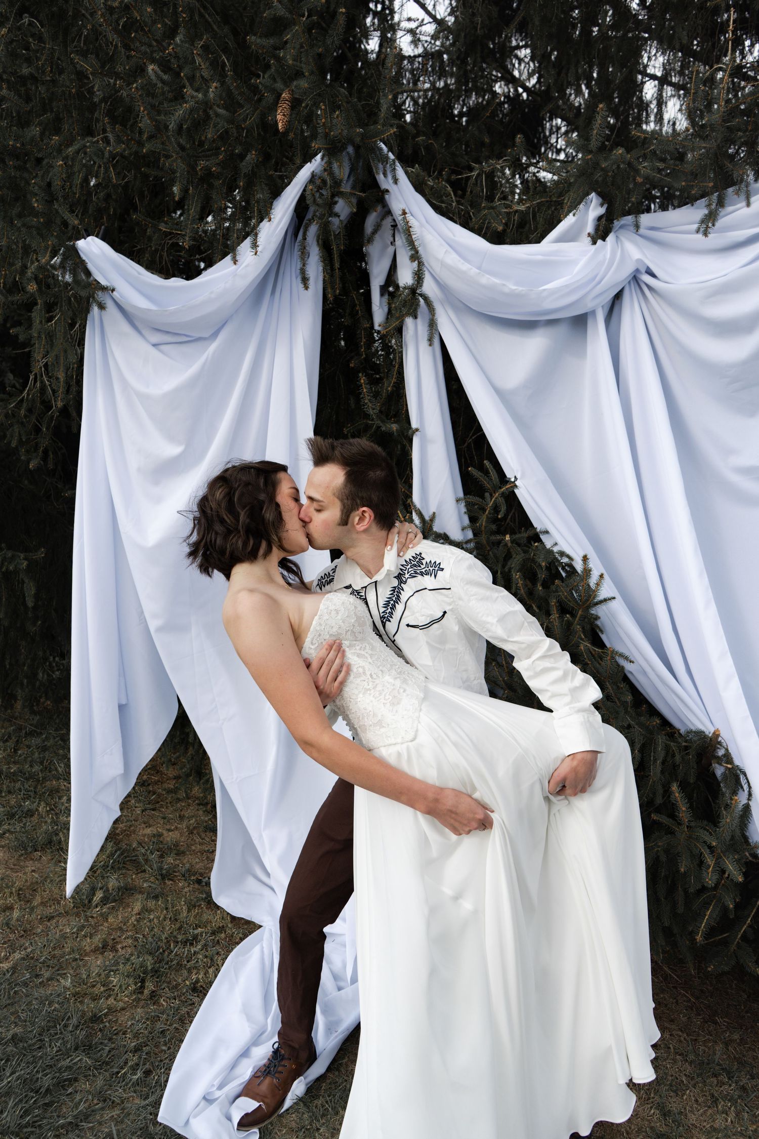 A romantic wedding photoshoot sequence with white fabric backdrop draping in an outdoor wooded setting.