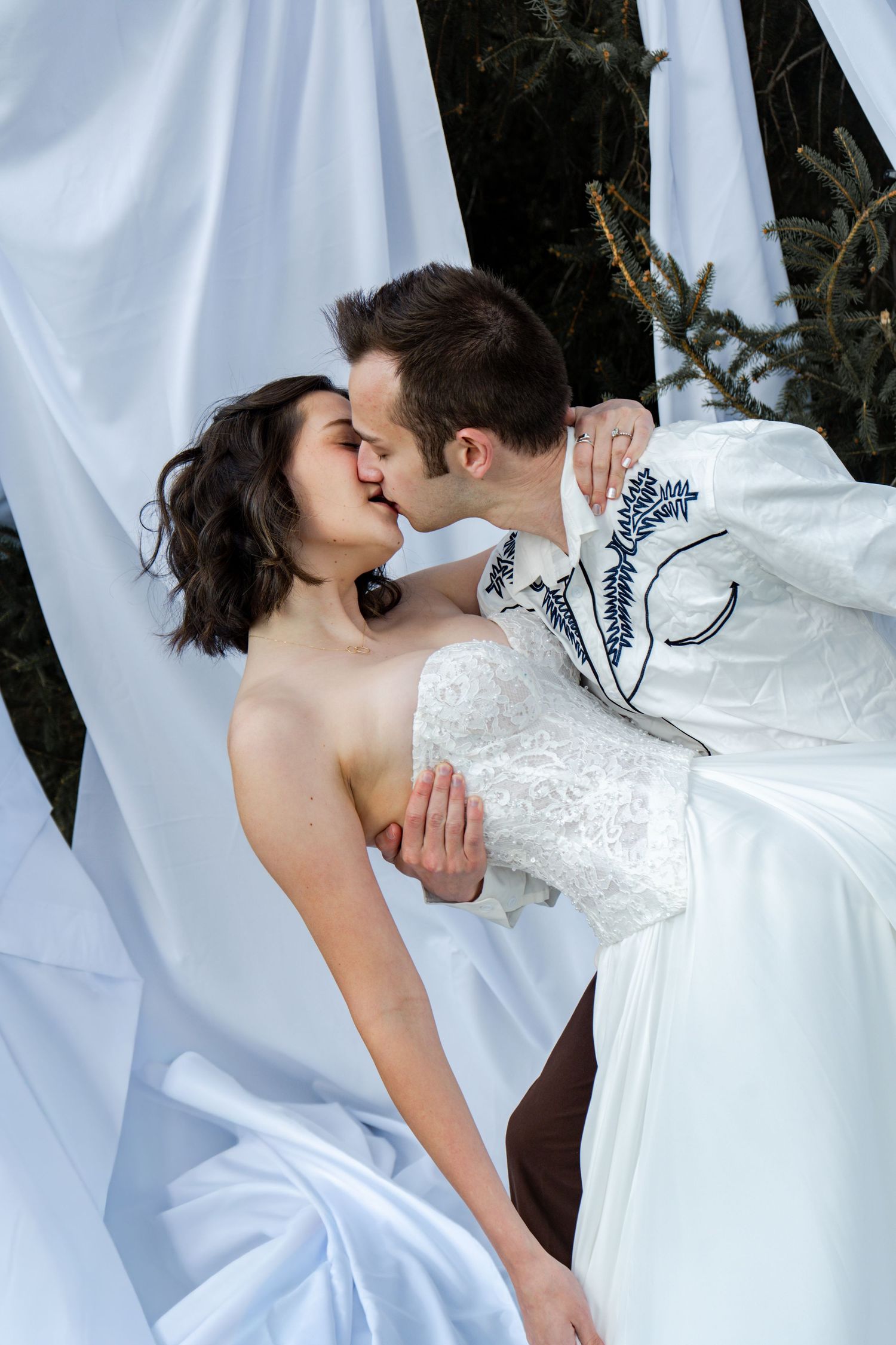 A romantic wedding couple shares a tender kiss against flowing white curtains in a sequence of intimate photos.