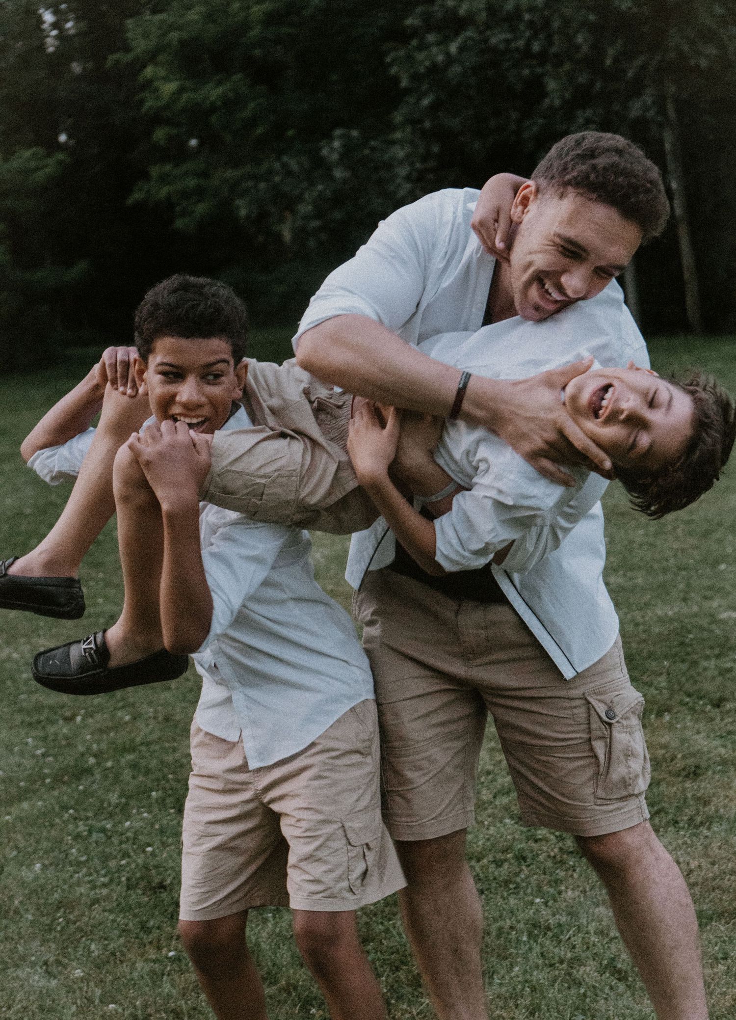 Two people in white and khaki outfits playfully interacting outdoors in a progressive sequence of candid moments.