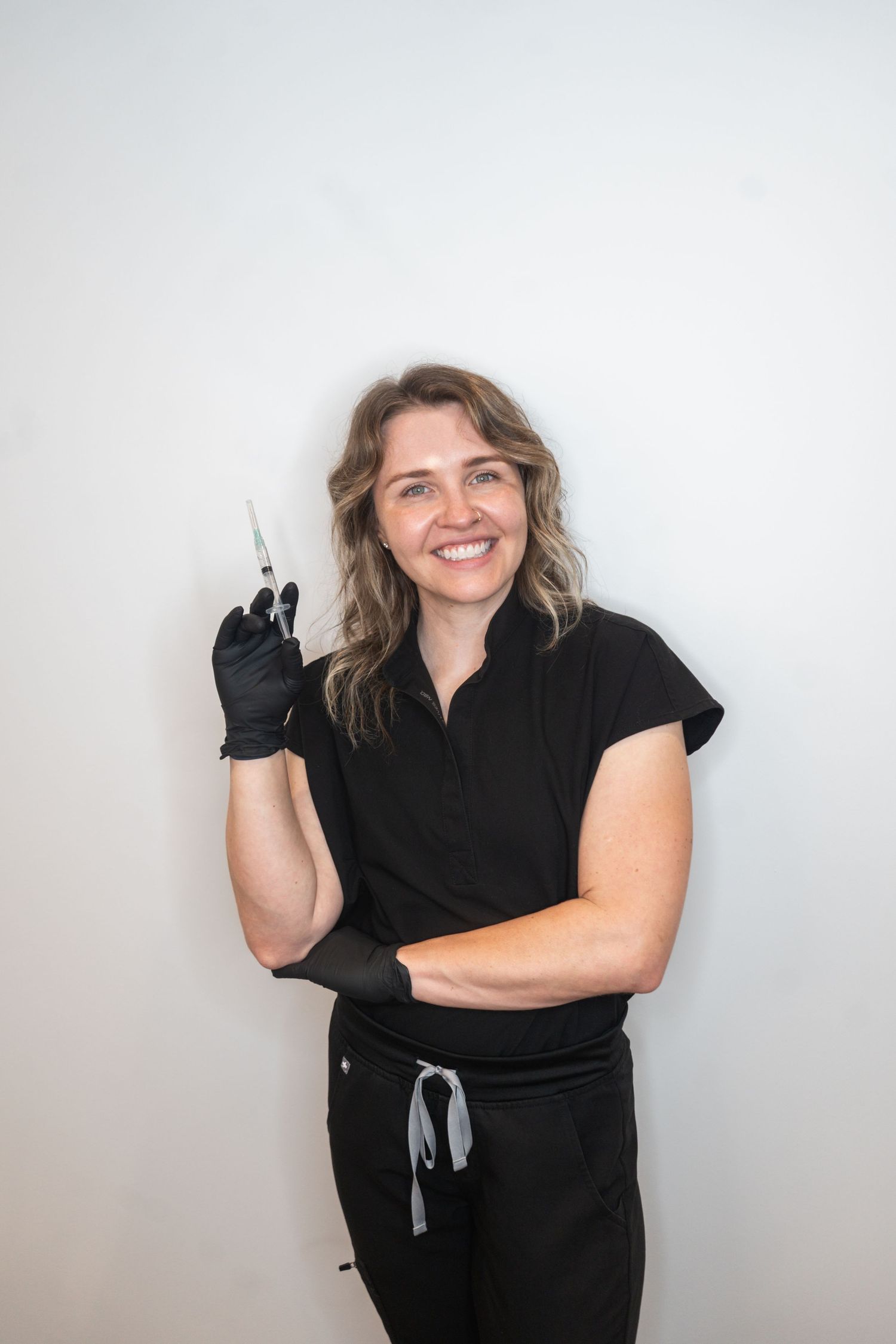Someone wearing all black clothing and gloves smiles and poses expressively in a photo collage against a white background.