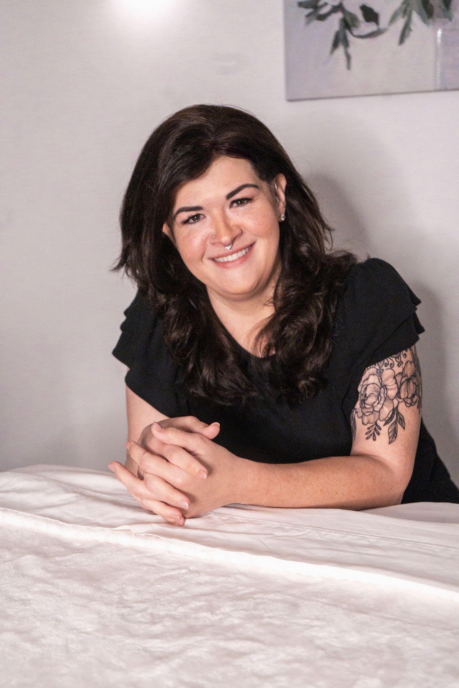 A sequence of images shows someone with dark hair lying on a white bed in a black top, showing multiple relaxed poses.
