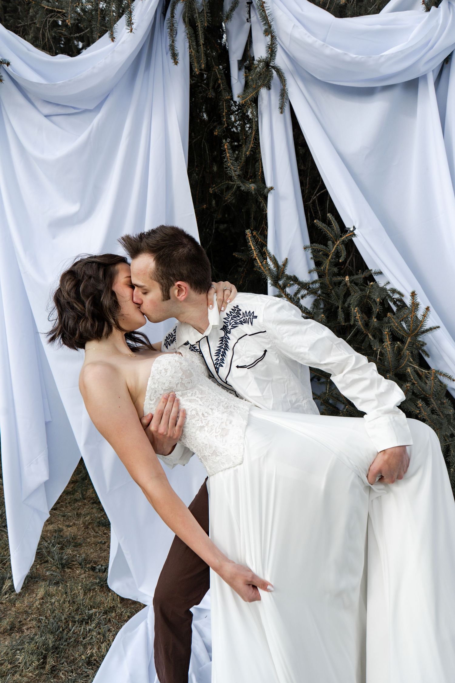 A series of romantic wedding photos showing couples kissing in front of white fabric draped outdoors.