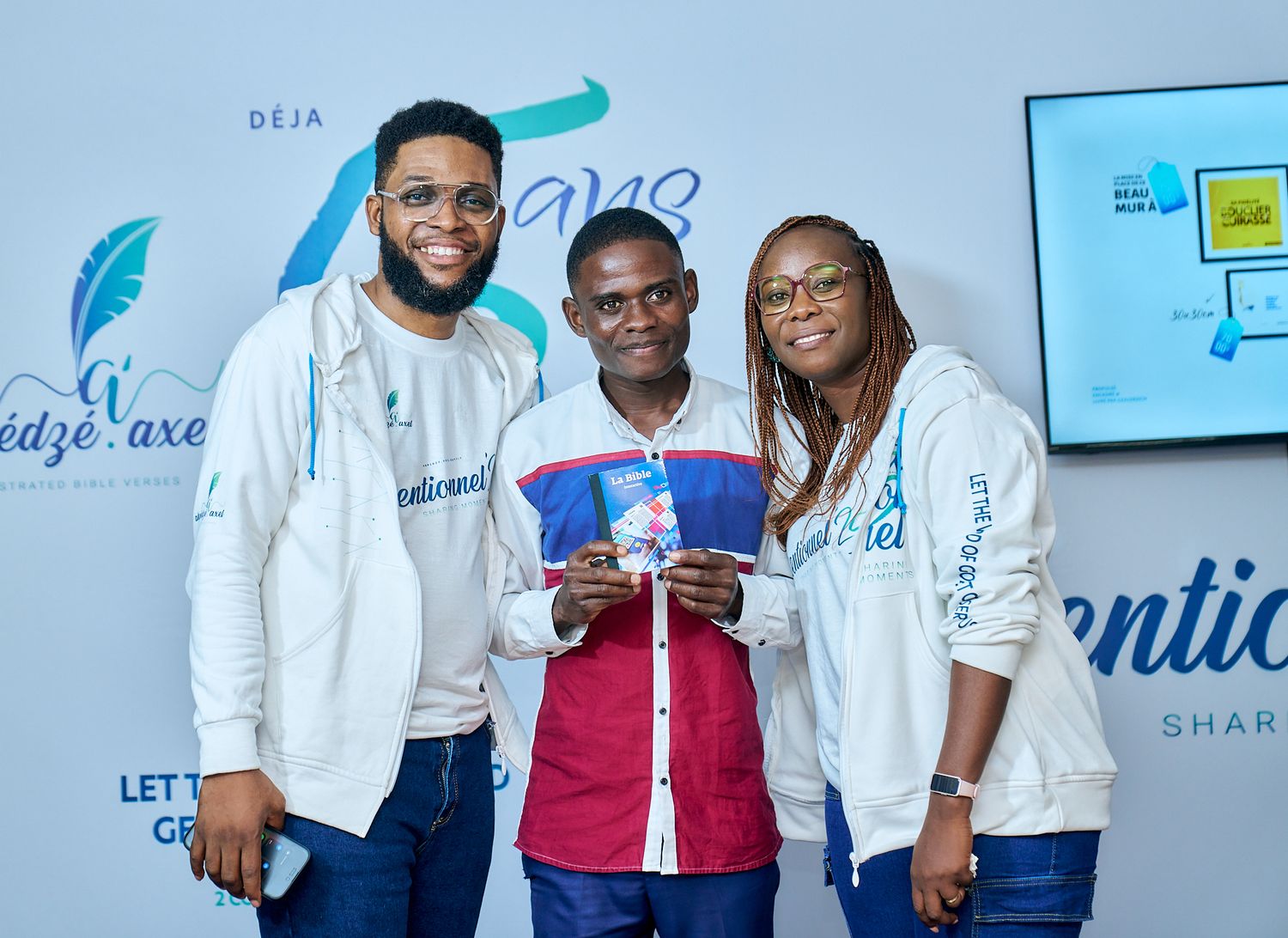 sharing moment called intentionnel attendees in coordinated white tops and blue jeans posing for photos.