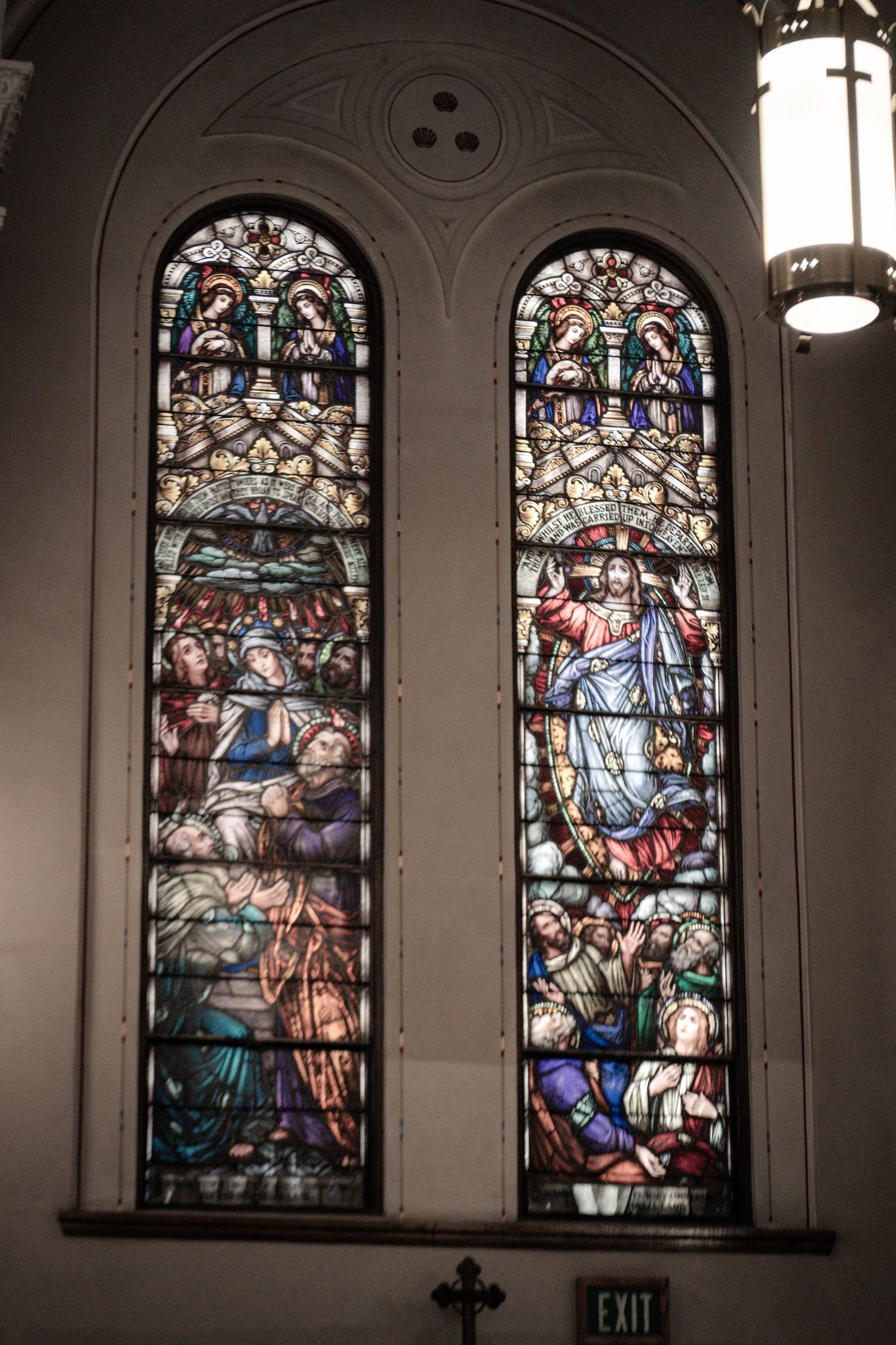 Beautiful stained glass windows depicting religious scenes line the church walls.