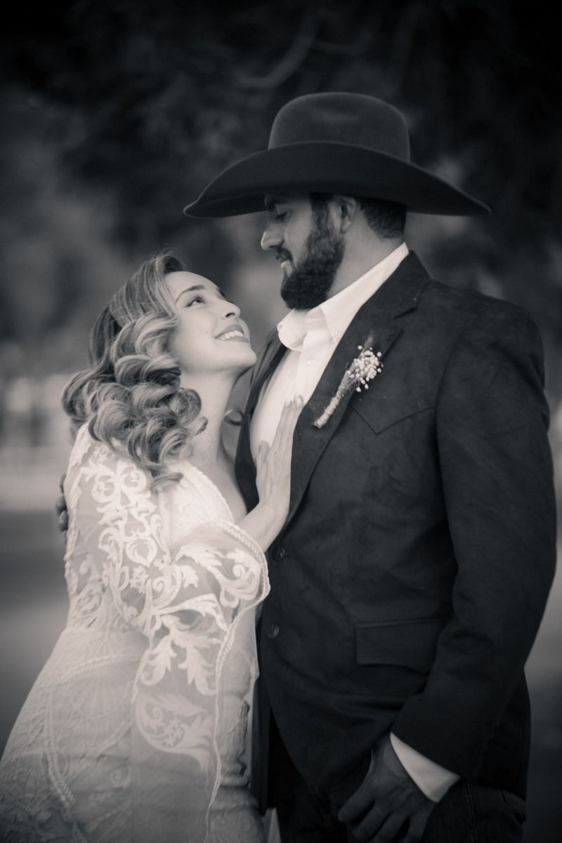 Romantic black and white portrait of newlyweds in western attire.