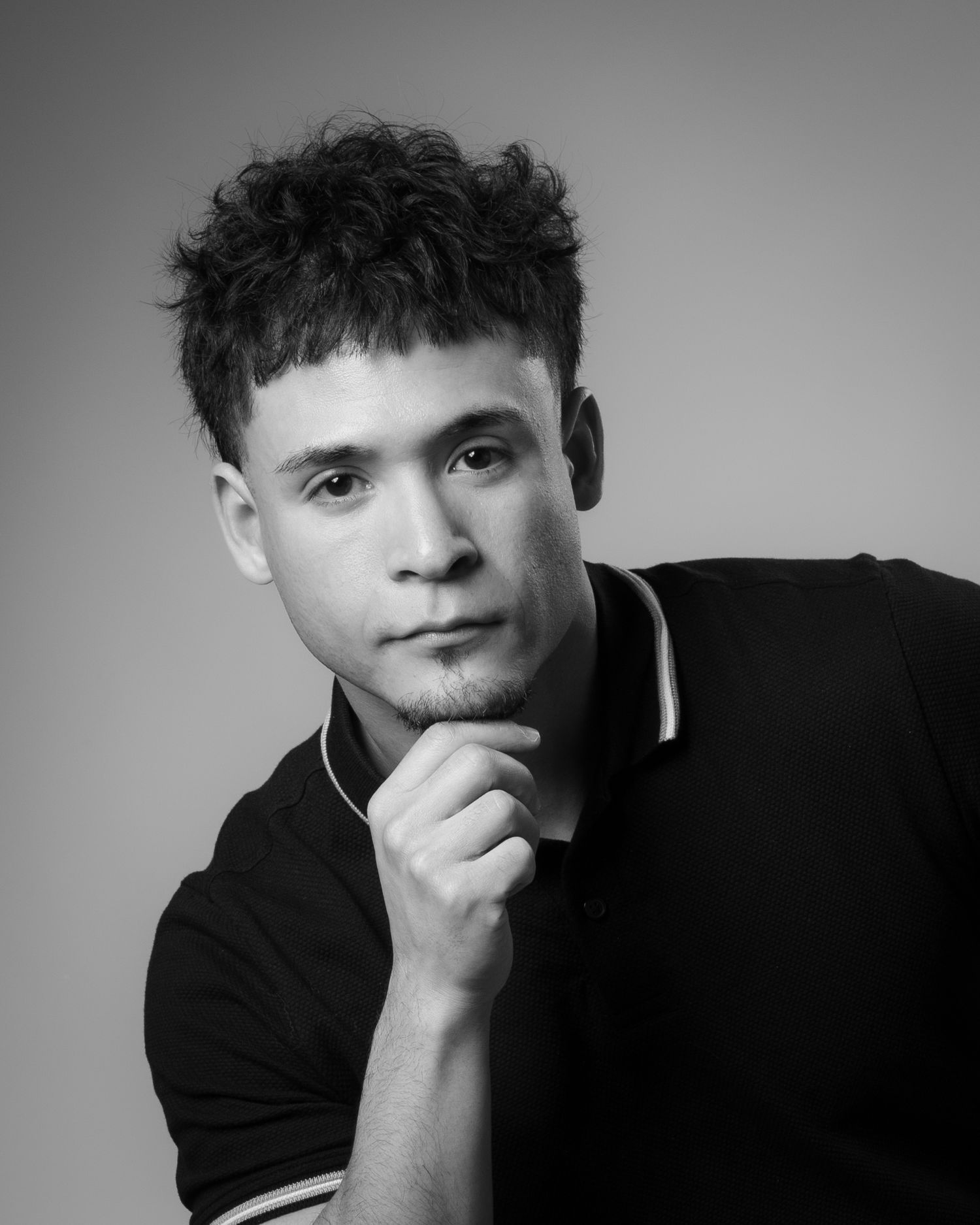 A series of black and white portraits showing contemplative expressions in dramatic lighting against a simple background.