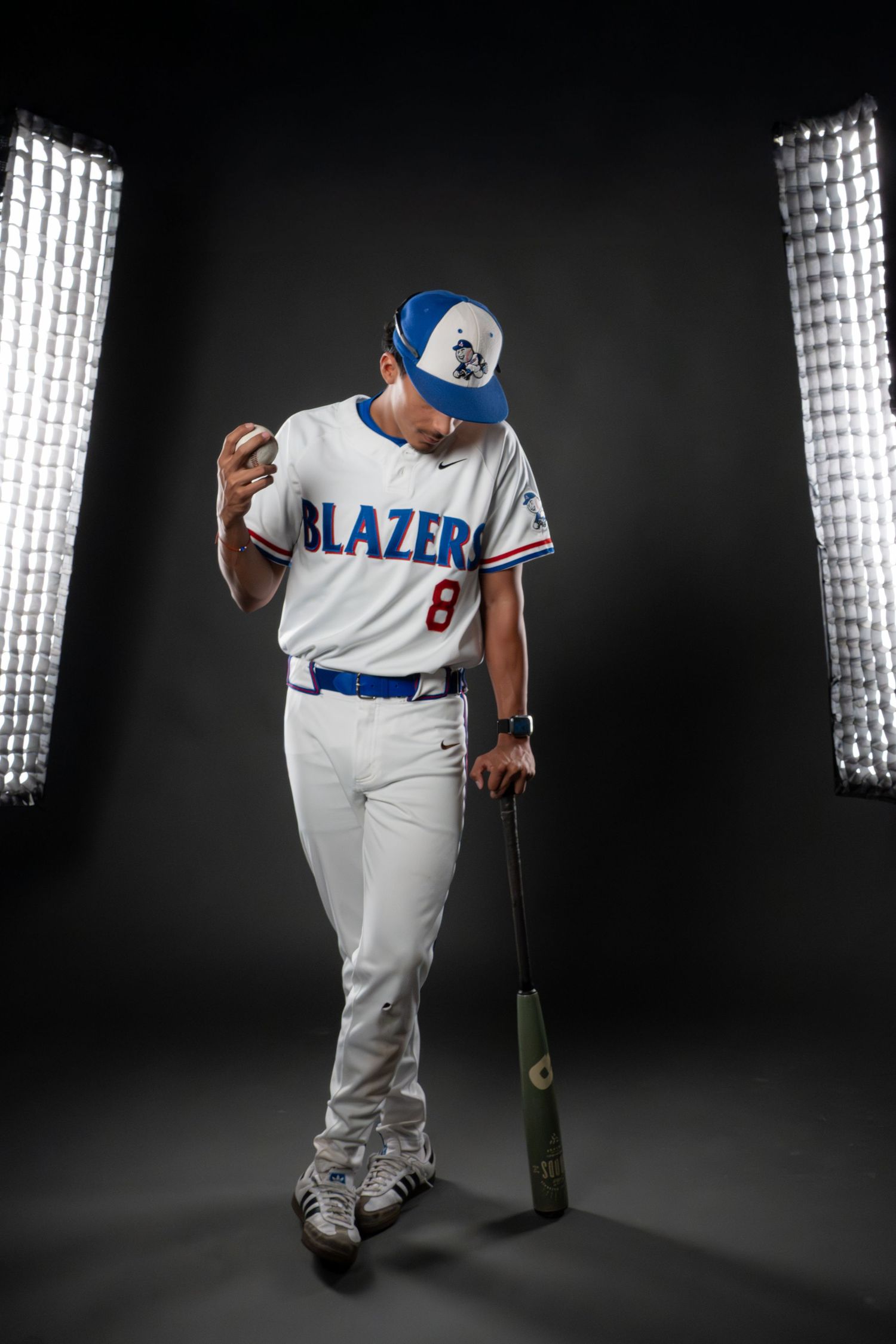 Baseball player in Blazers uniform #8 poses with bat in professional studio lighting setup.