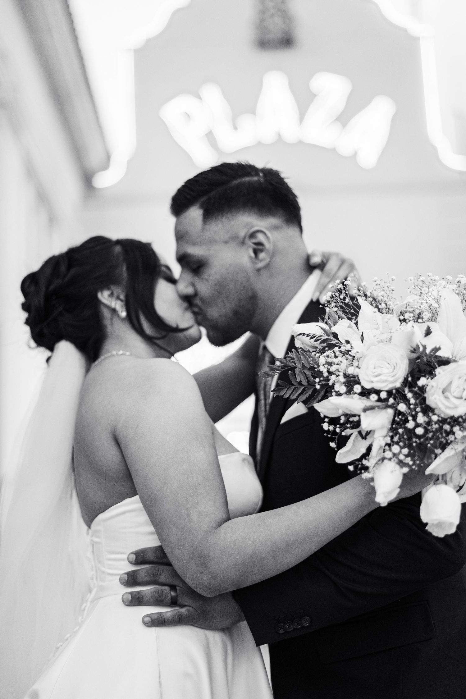 Black and white romantic wedding portrait with floral bouquet.