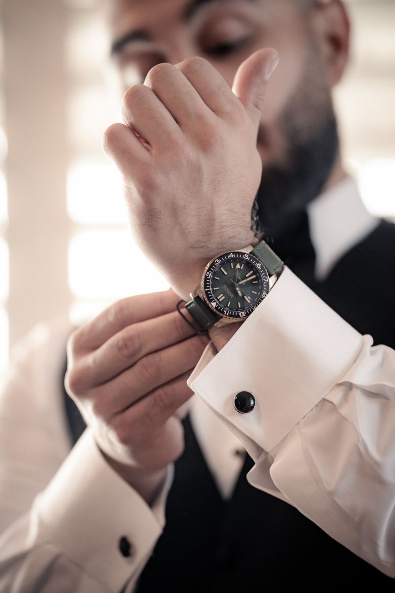 Detailed shot of formal wear accessories and wristwatch.