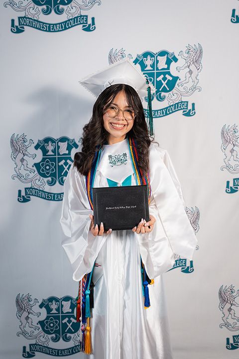 Graduate in white academic regalia poses with diploma against decorative background in celebratory photo series.