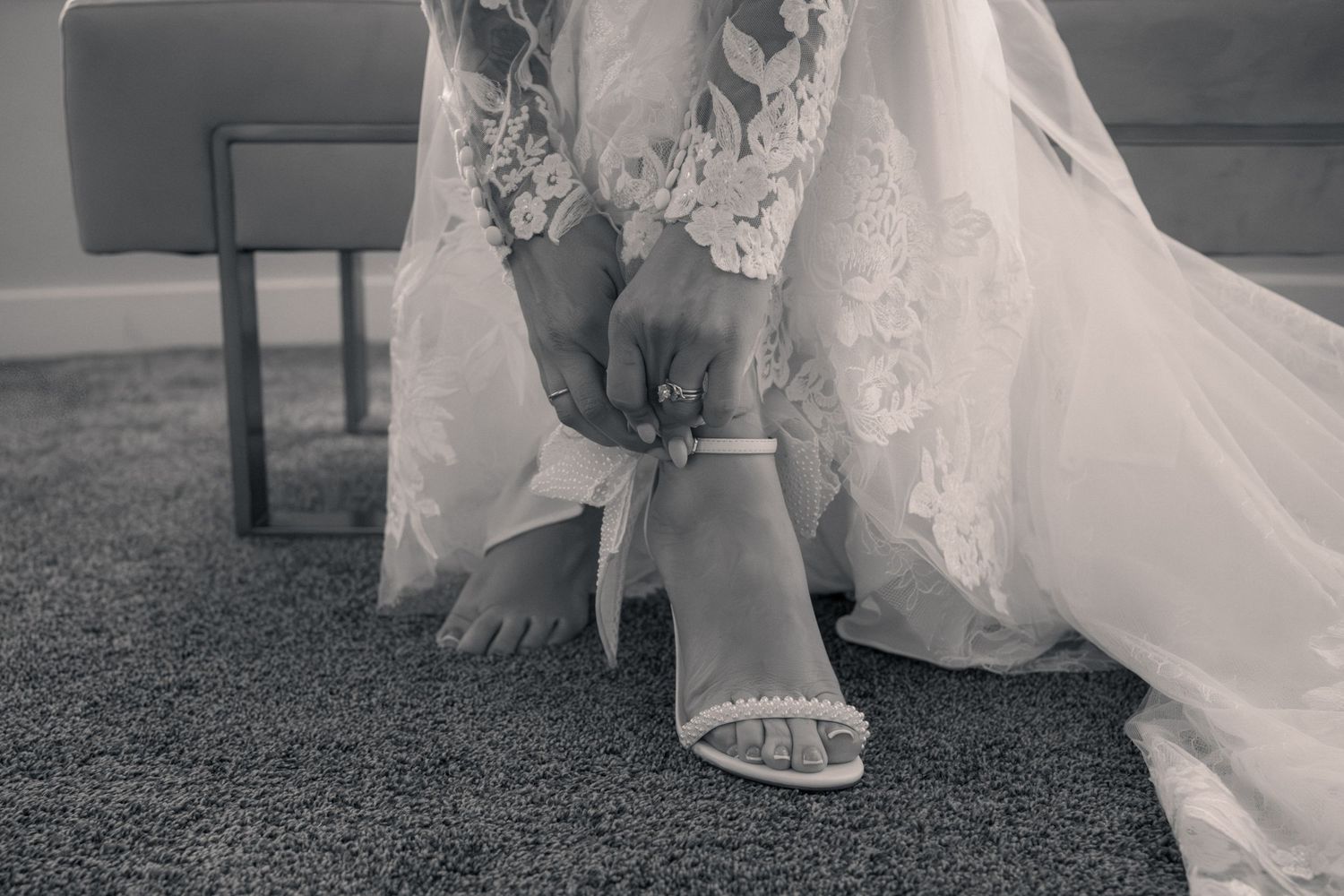 Black and white detail shots of a bride's flowing white wedding dress and shoes during a romantic outdoor ceremony.